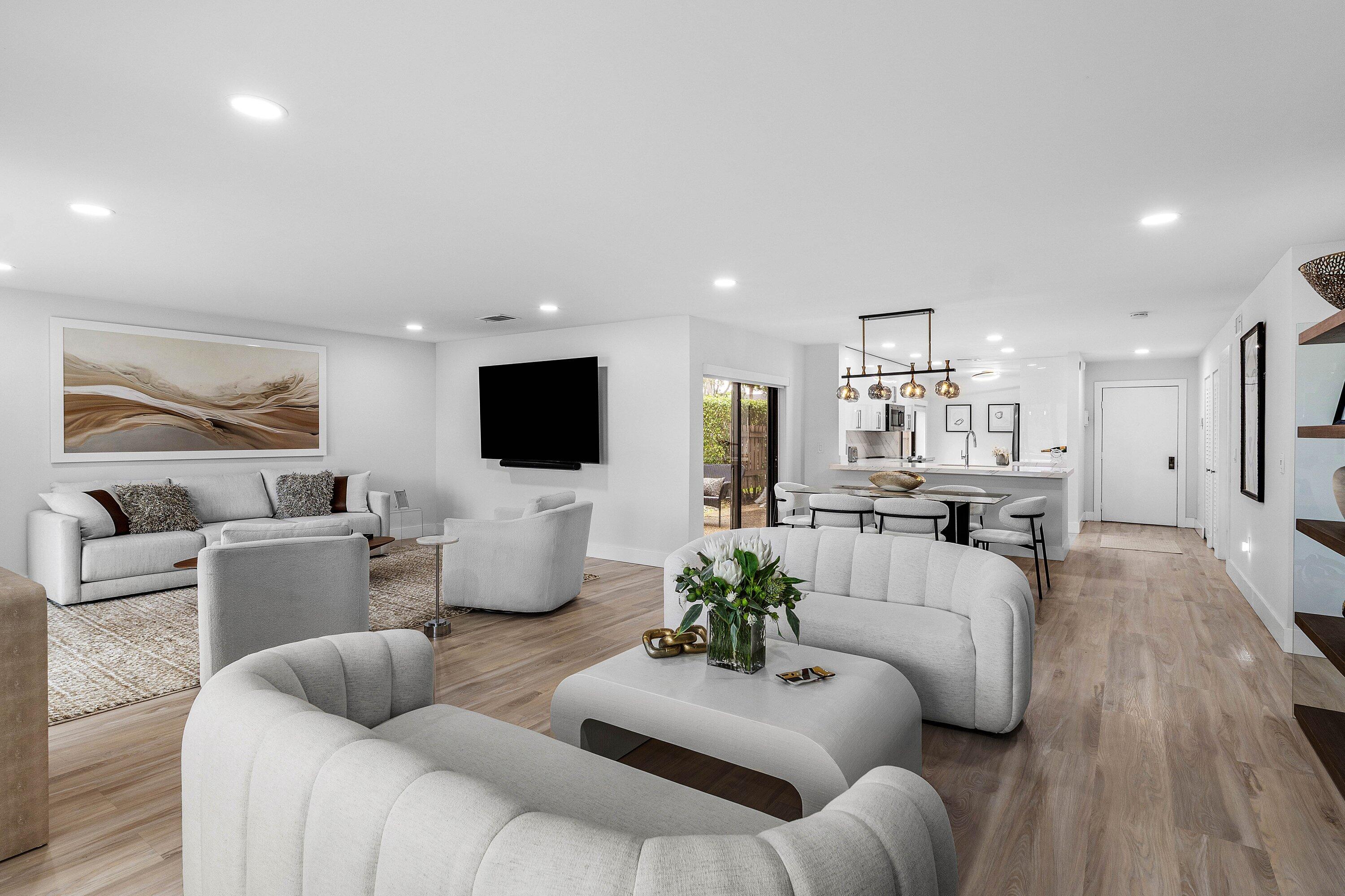 Open floor plan featuring wood-finish flooring, recessed lighting, and a multi-pendant island light fixture
