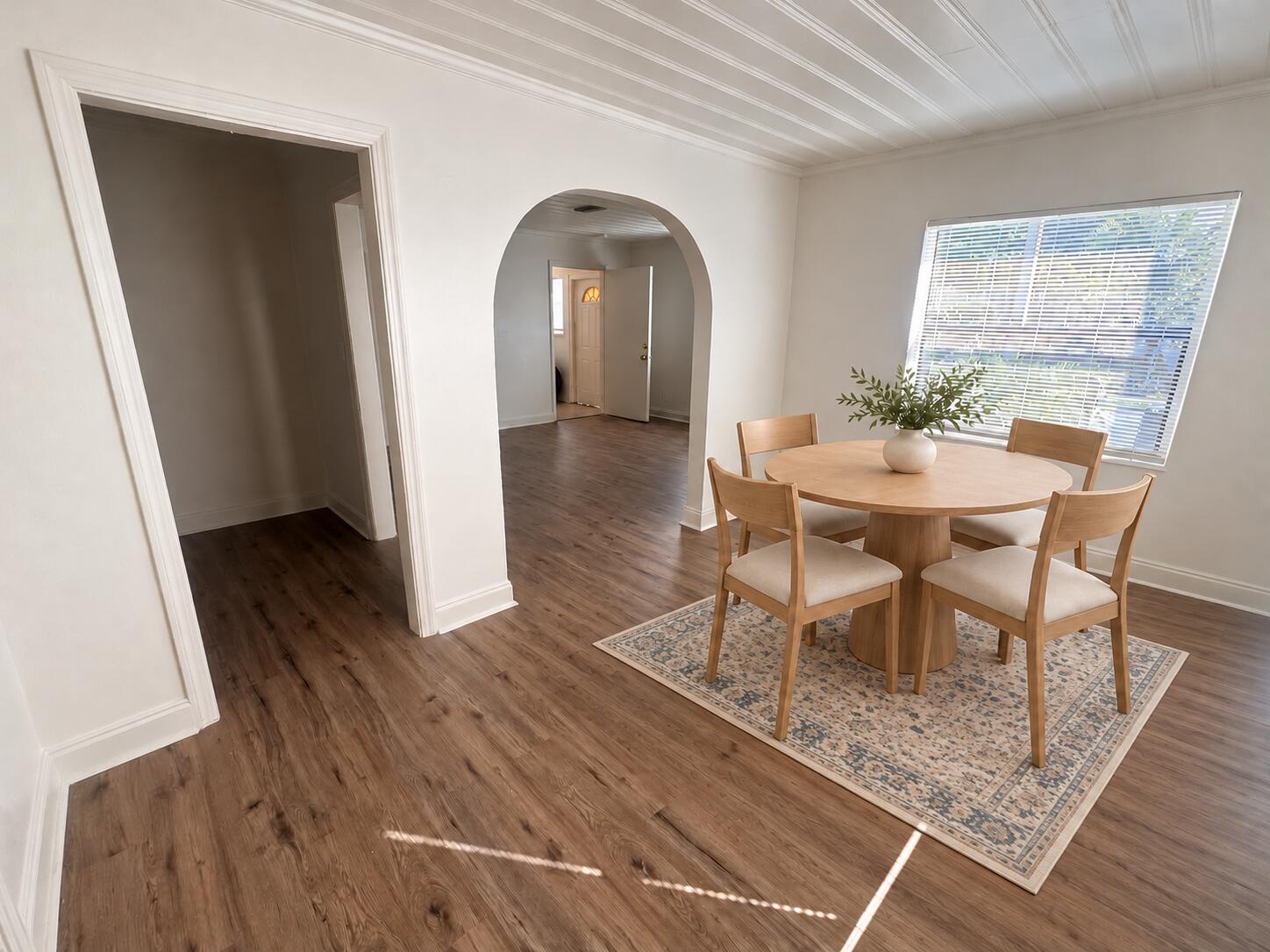 Dining room with smaller patterned rug