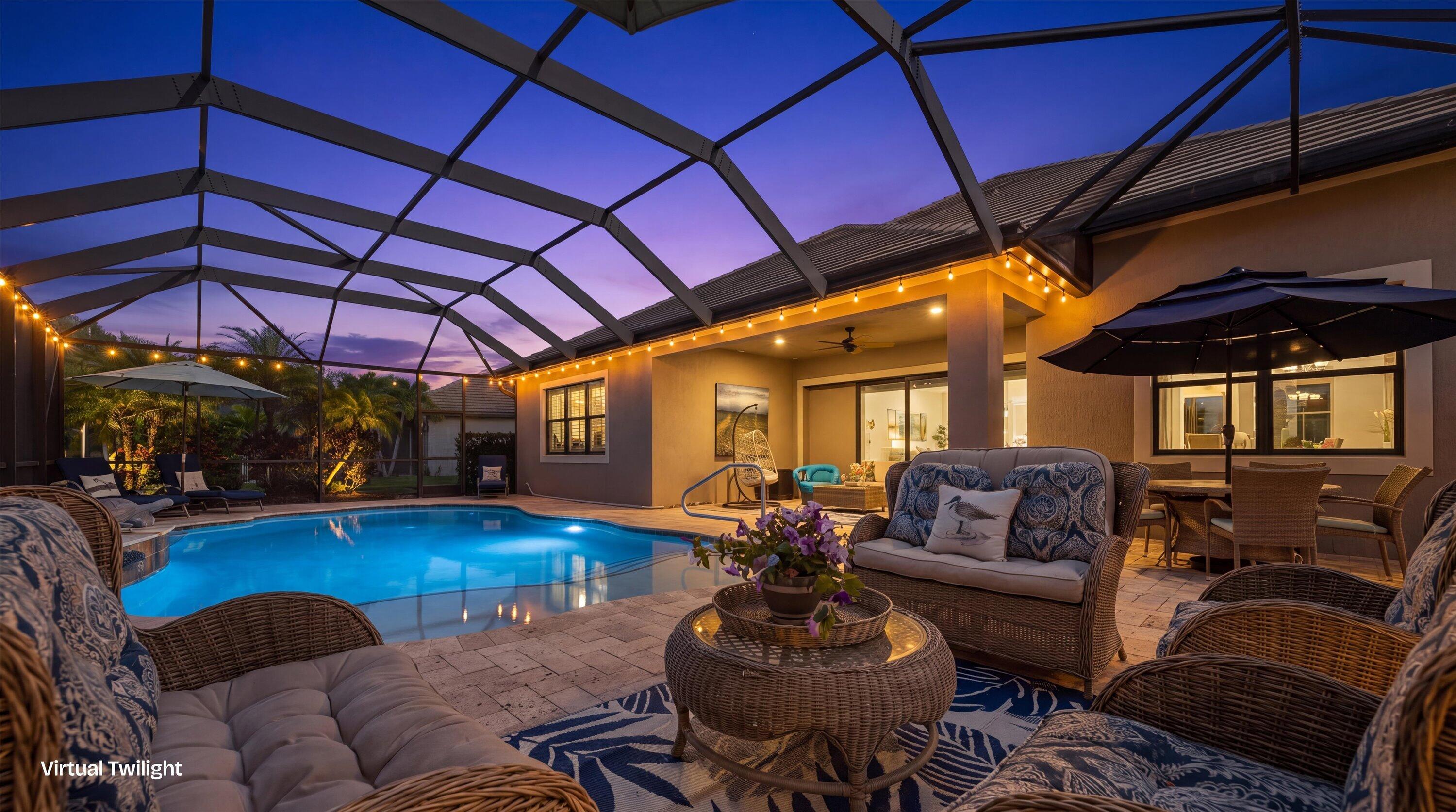 Screened pool enclosure featuring a stone-paver deck and recessed lighting