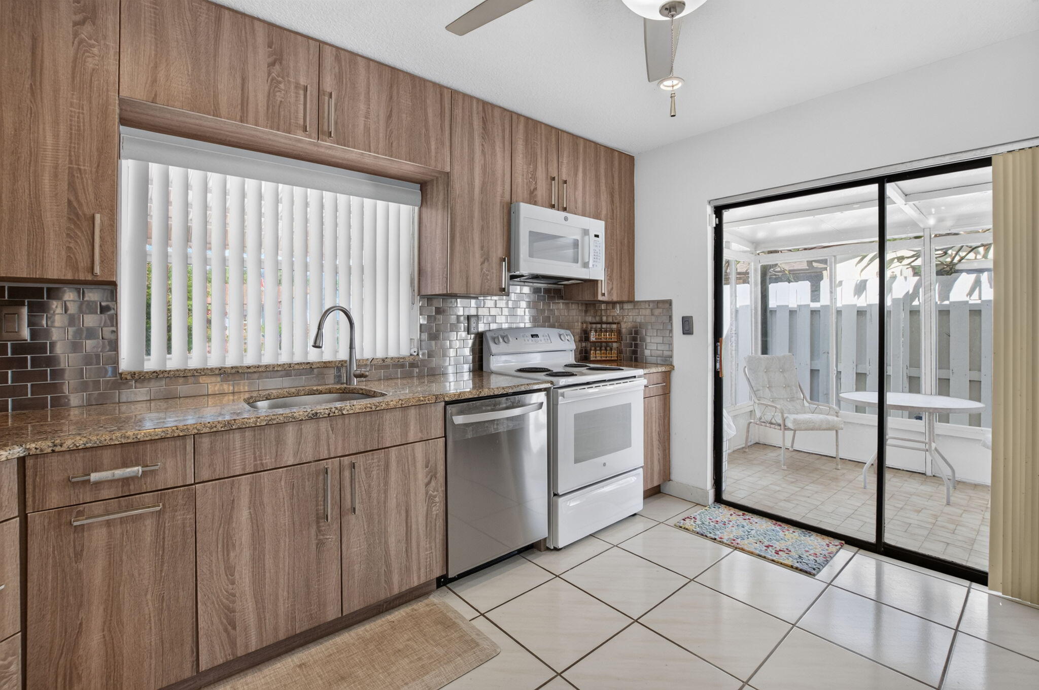 Features a bonus covered patio located off the kitchen. Features a bonus covered patio located off the kitchen.