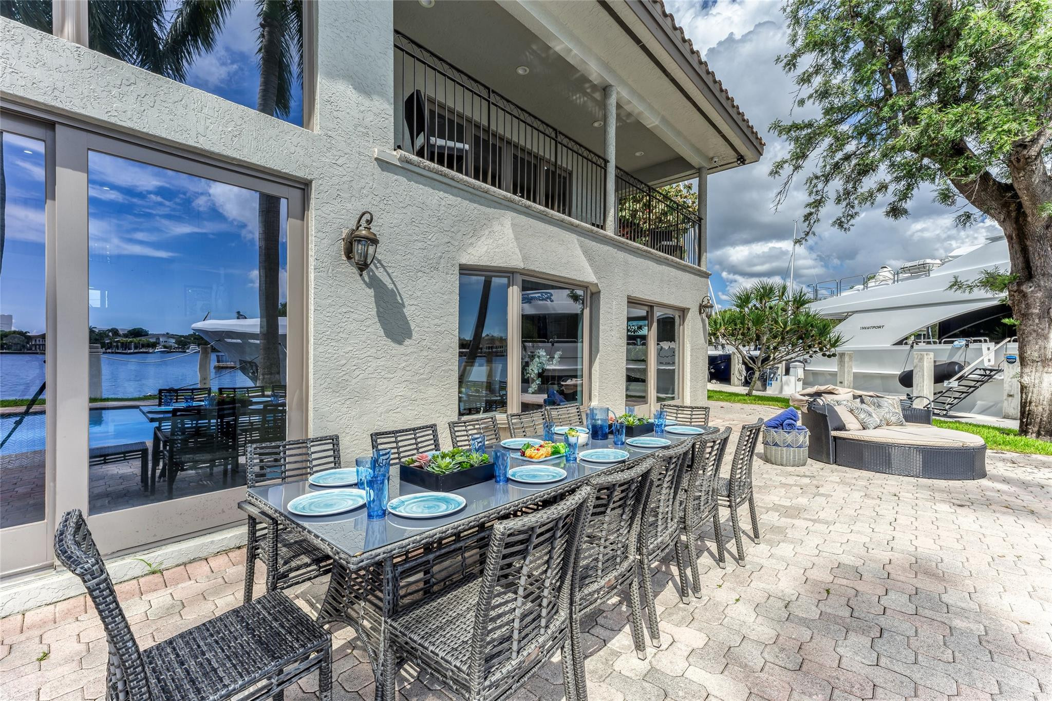 Outdoor waterfront Point Lot with pool area with outdoor dining, lounge chairs, BBQ & siting area.