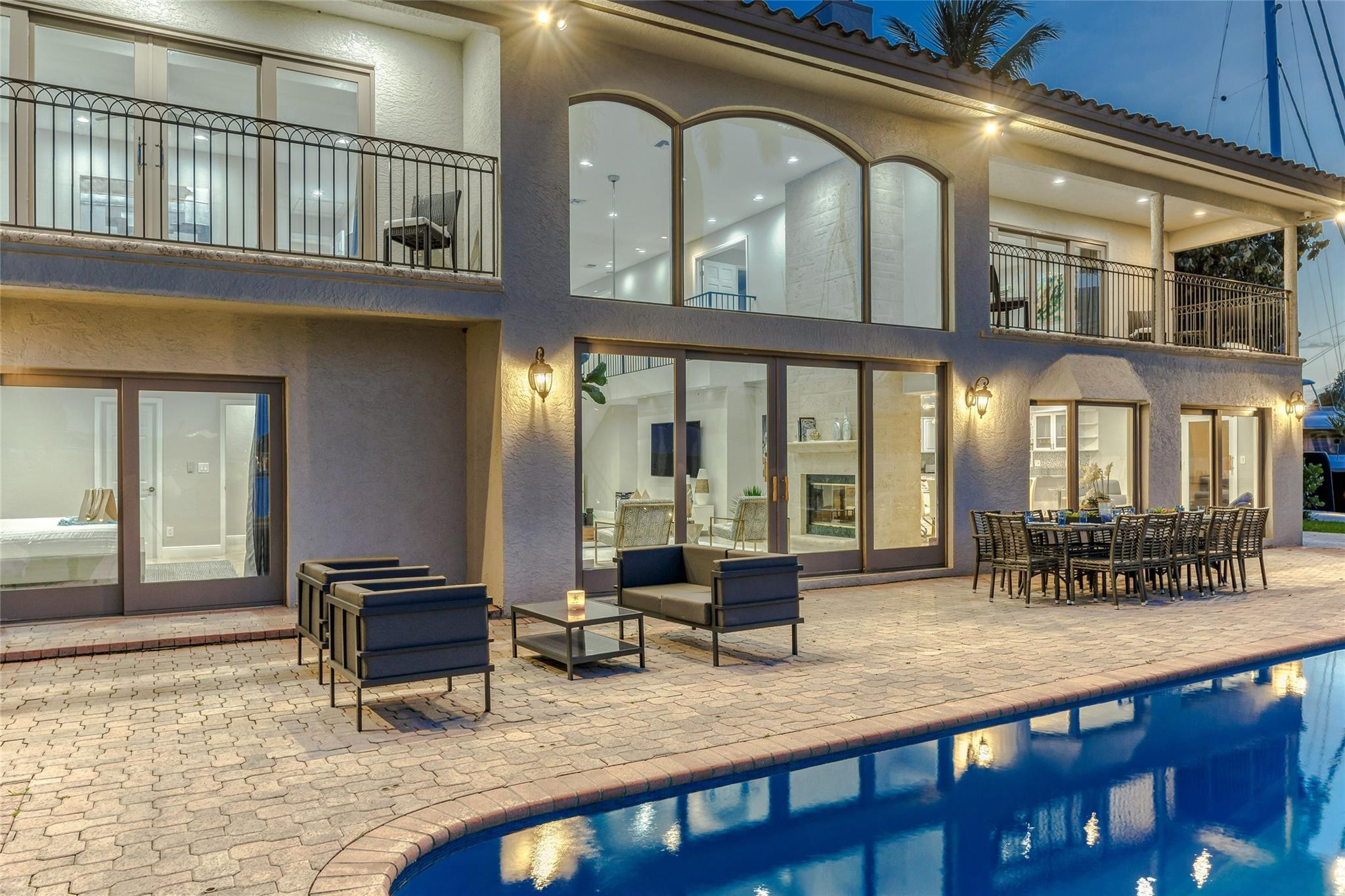 Outdoor waterfront Point Lot with pool area with outdoor dining, lounge chairs, BBQ & siting area.