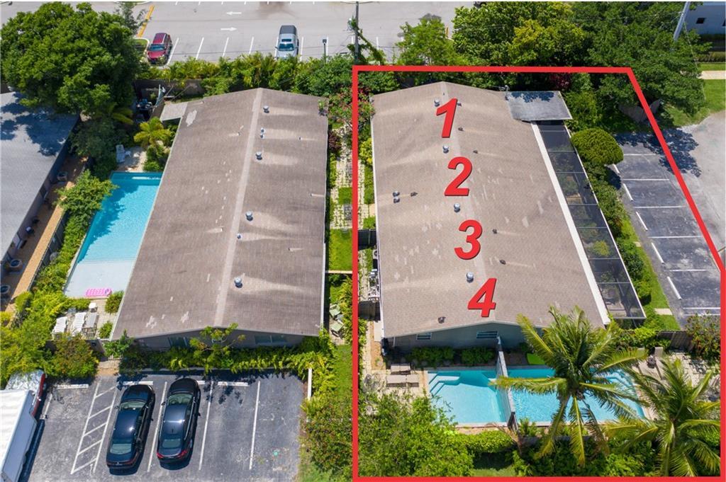Aerial view of building, pools and parking. This is end unit #1.