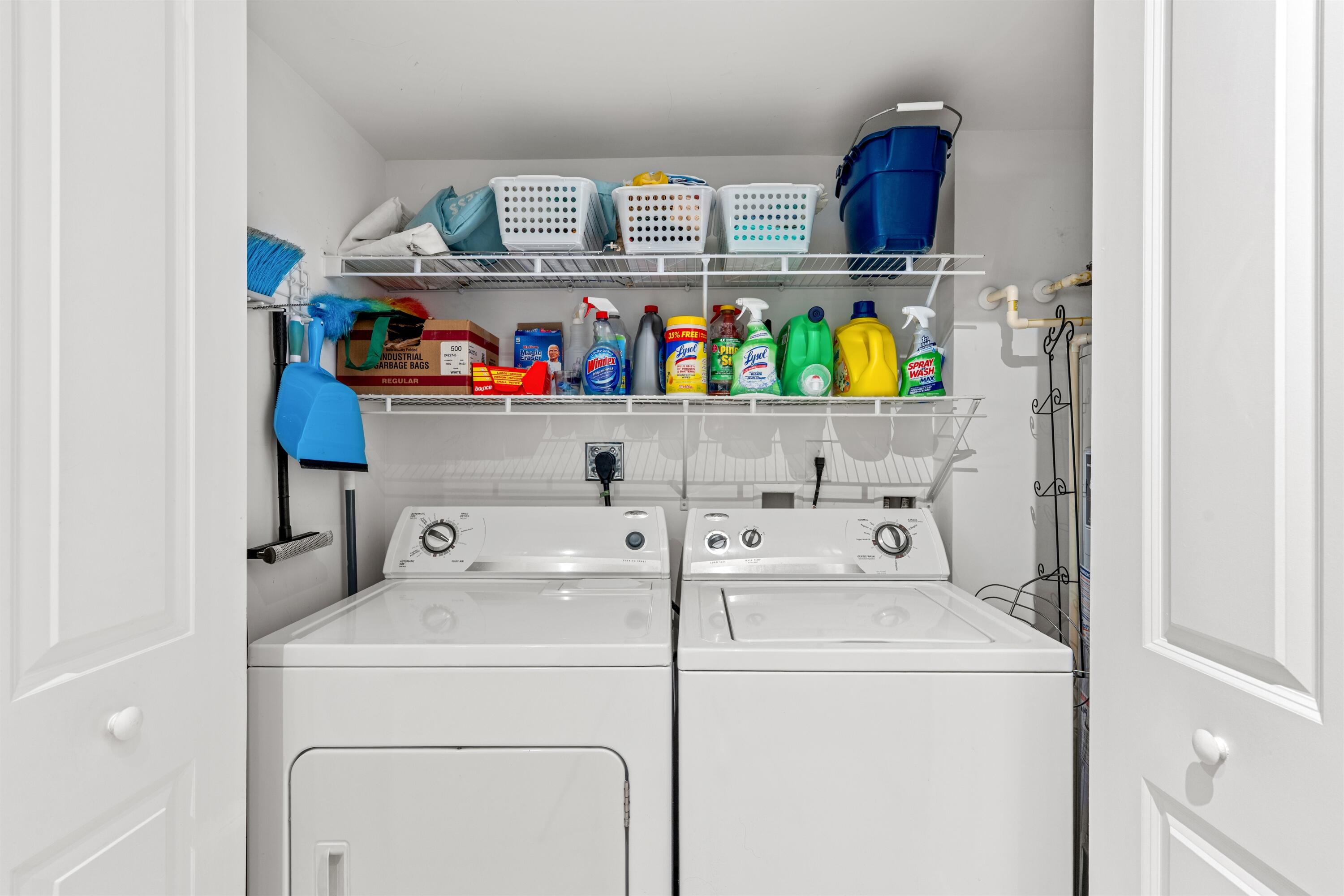 Utility closet featuring dual wire-grid storage shelving and bi-fold access doors