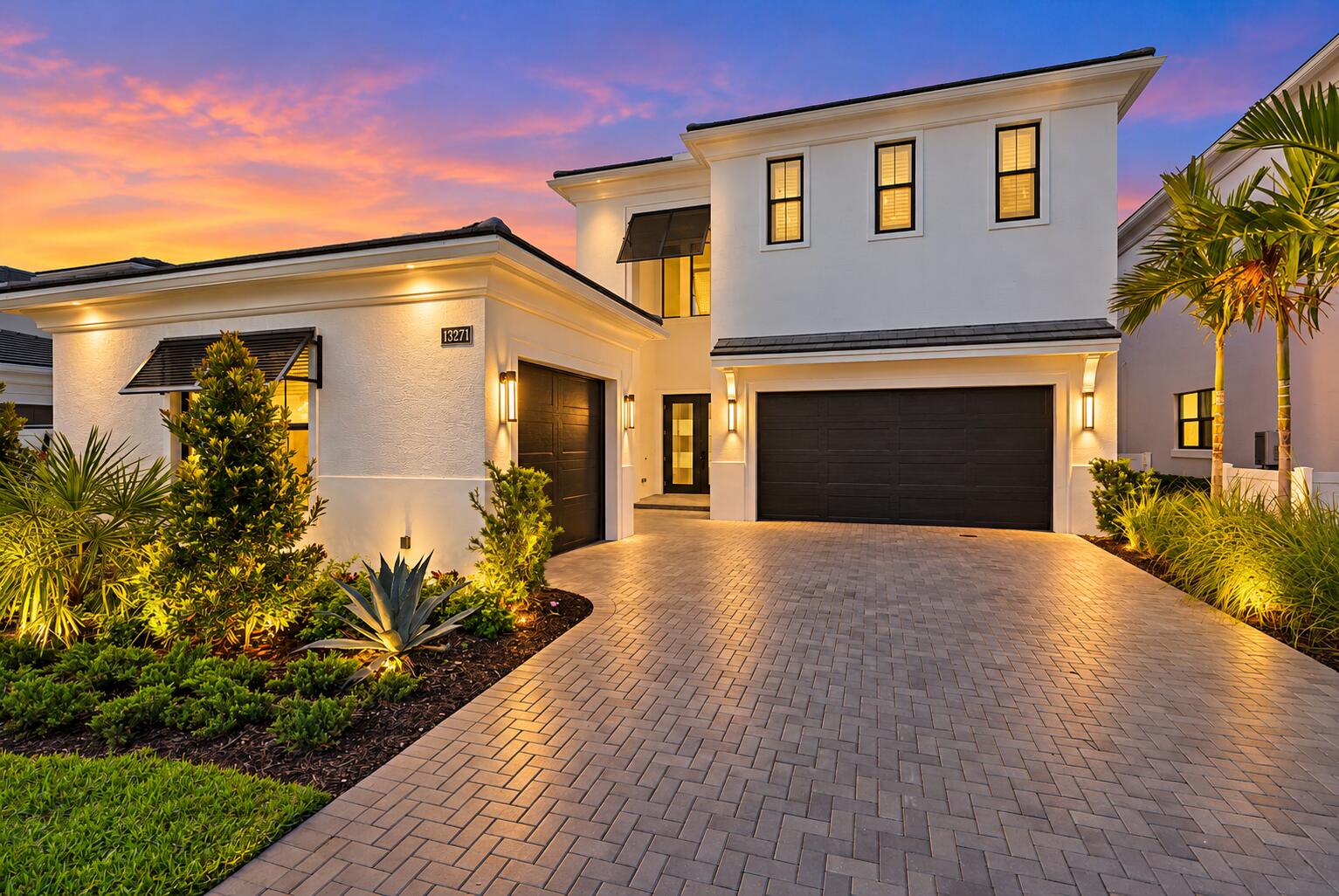 Twilight Luxury Home with Glowing Landsc
