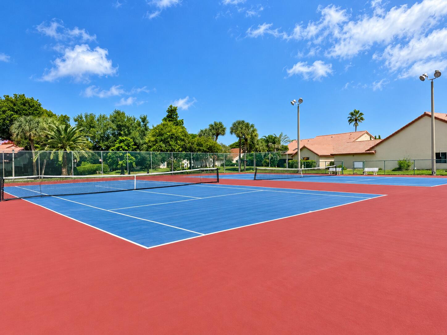 Sunny Tennis Courts Beneath Blue S