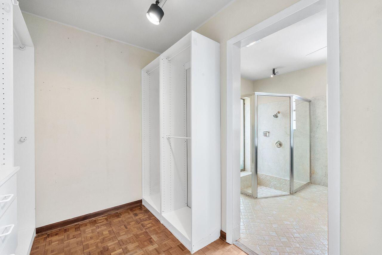 Walk-in closet with bathroom adjacent