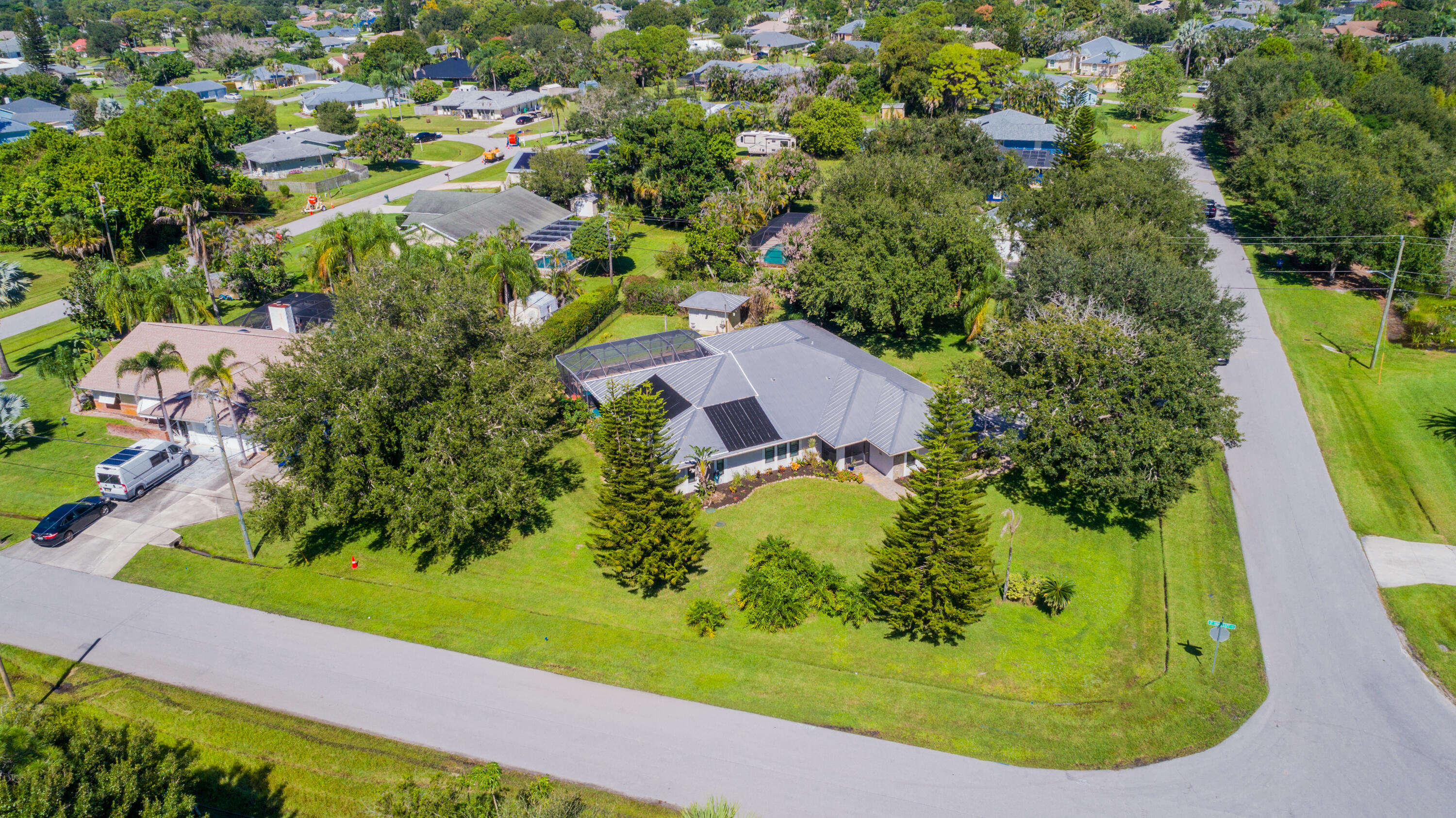 Expansive lawn area featuring mature trees, established landscaping
