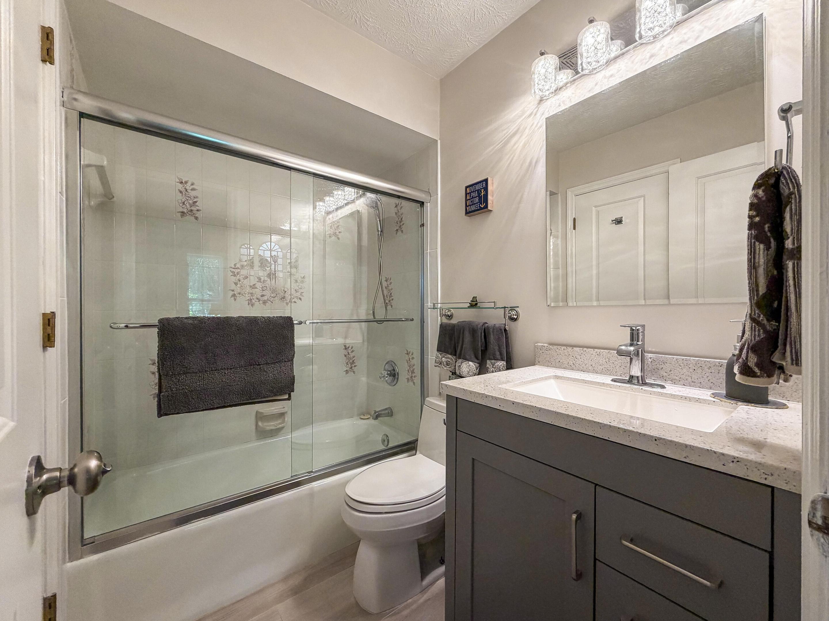 Bathroom 3 is conveniently located next to Bedroom 4 and features a tub/shower combination, updated vanity, and modern finishes.
