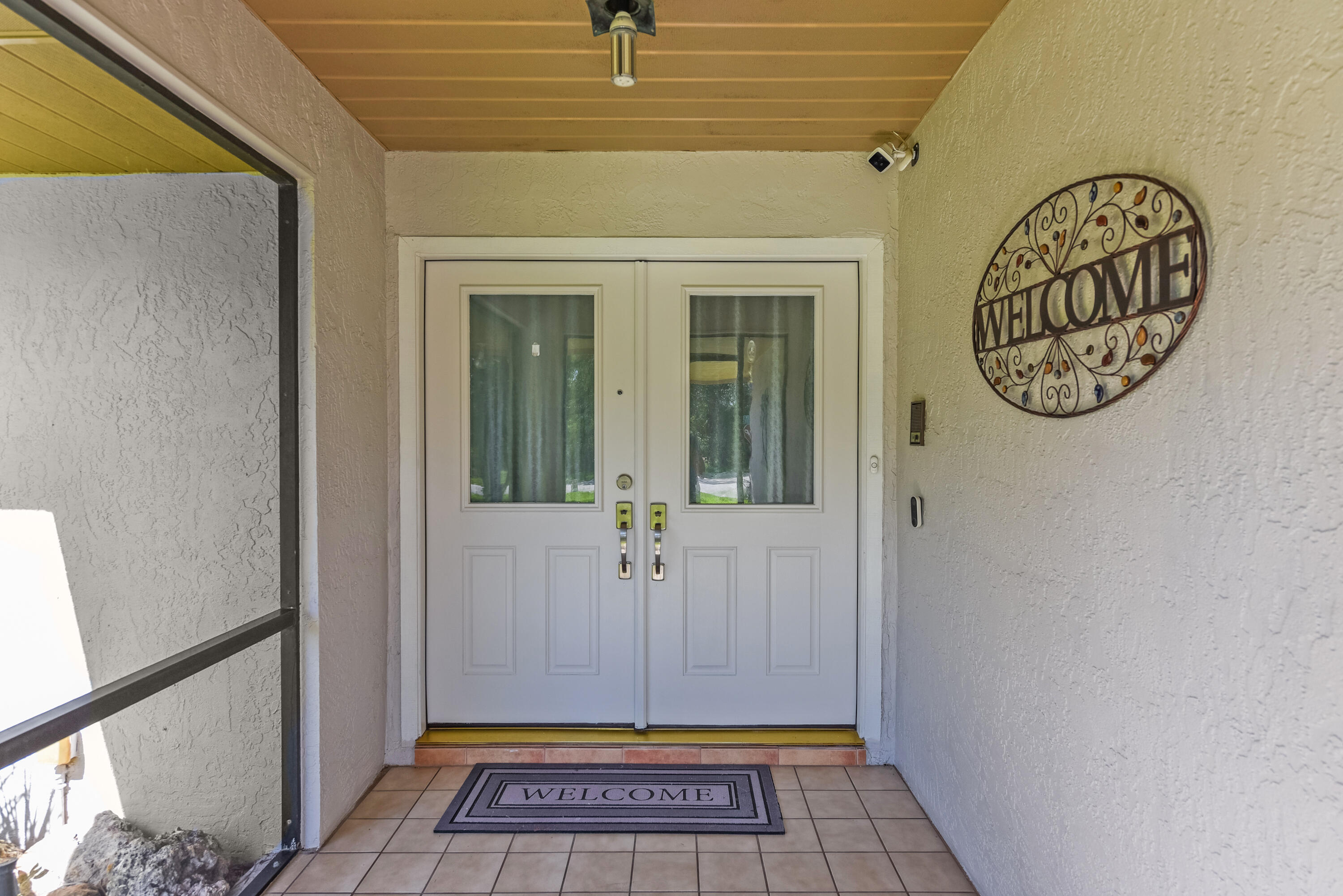 An inviting covered entry with elegant double doors welcomes you home.