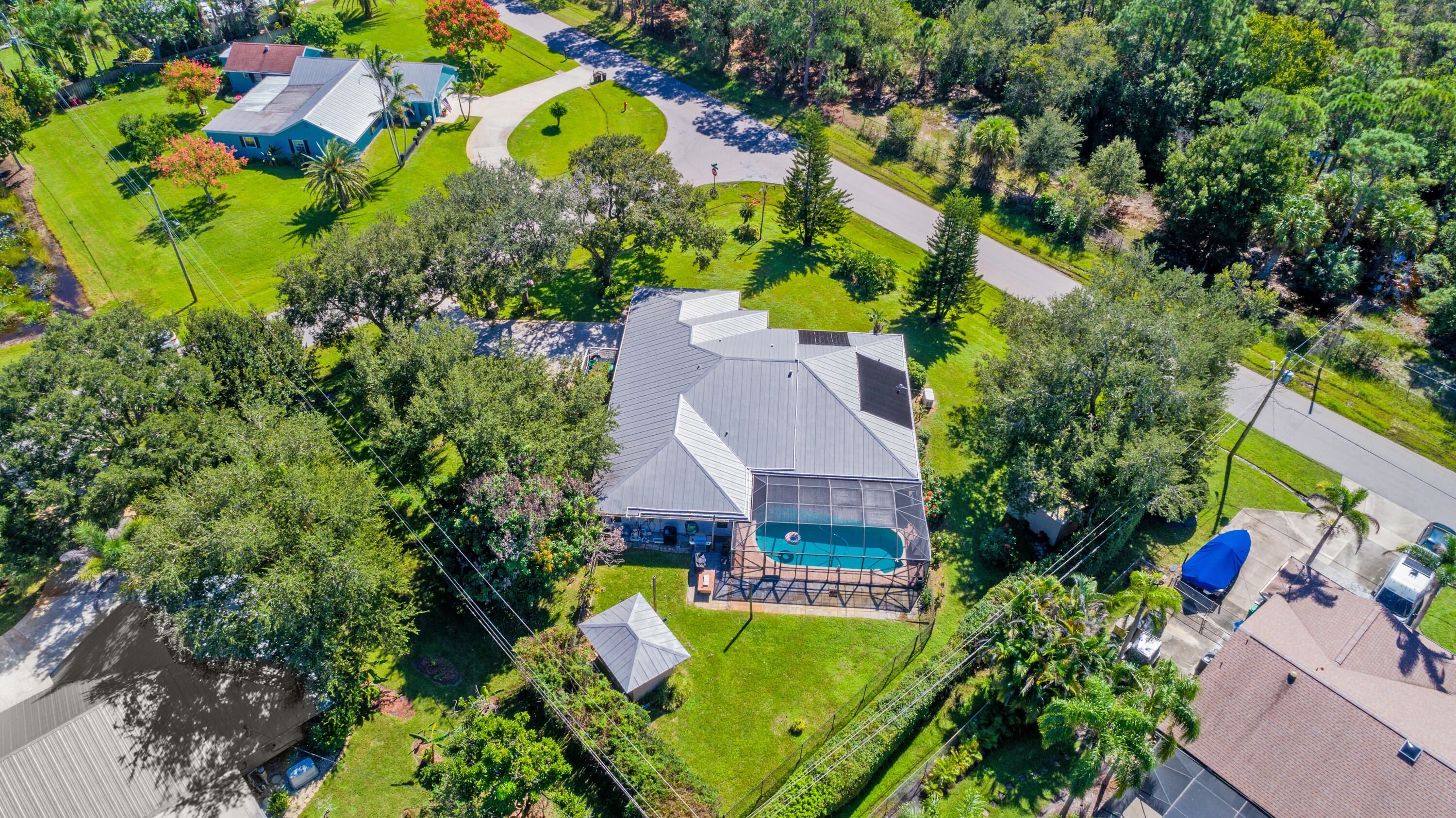 This aerial view captures the impressive size of this .49-acre corner property, featuring a screened pool, mature shade trees, fully fenced backyard, and plenty of room to enjoy the outdoors. No HOA! This aerial view captures the impressive size of this .49-acre corner property, featuring a screened pool, mature shade trees, fully fenced backyard, and plenty of room to enjoy the outdoors. No HOA!