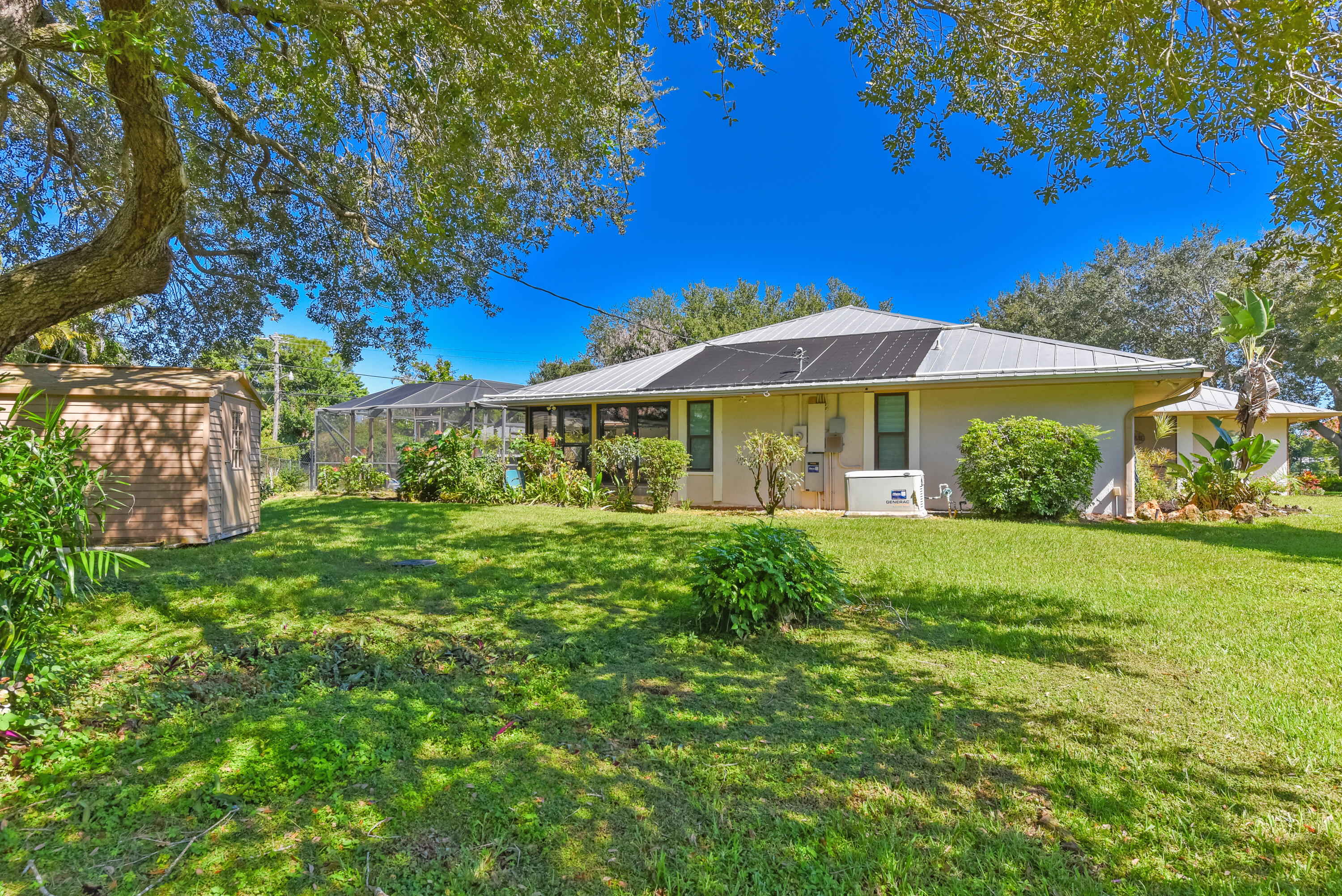 Enjoy the expansive backyard and screened pool area featuring a solar heated saltwater pool, perfect for year-round enjoyment, entertaining, and relaxed Florida living.