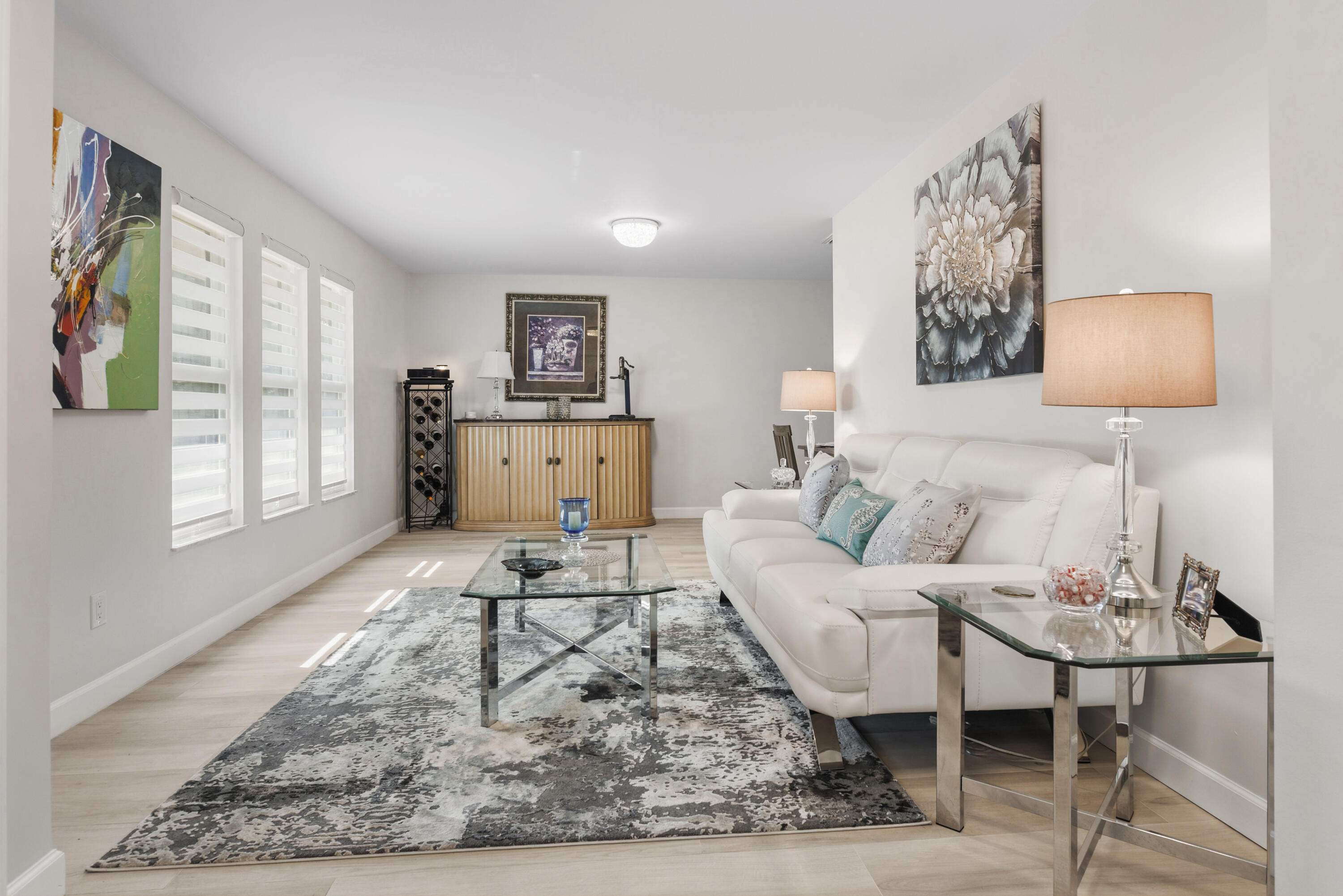Beautiful wide-plank flooring, stylish zebra shades, and an inviting layout create the perfect space for relaxing or entertaining.