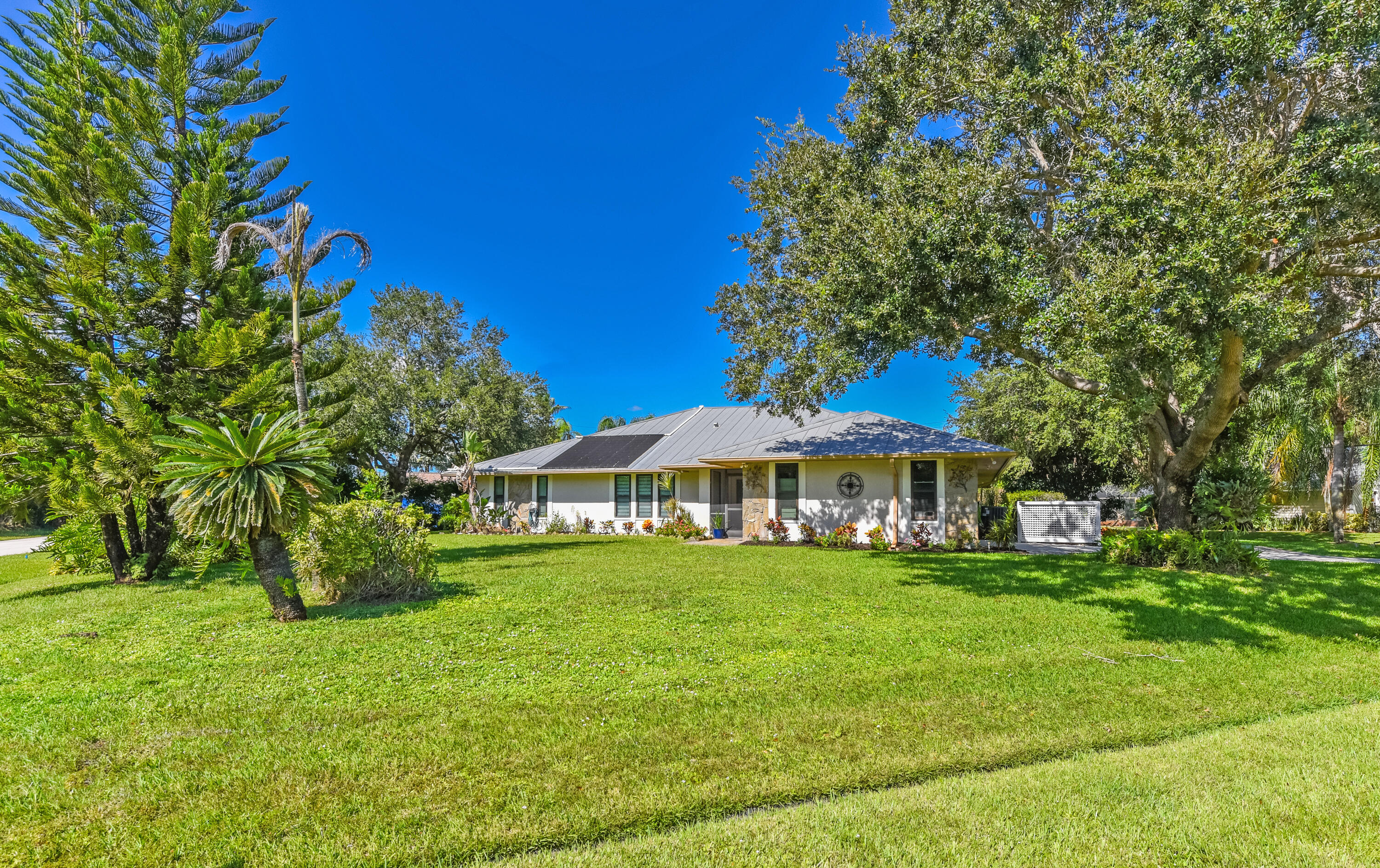Situated on a desirable .49-acre corner lot, this home features majestic shade trees, lush landscaping, and a beautiful green lawn. Plenty of room to enjoy Florida living with NO HOA! Situated on a desirable .49-acre corner lot, this home features majestic shade trees, lush landscaping, and a beautiful green lawn. Plenty of room to enjoy Florida living with NO HOA!