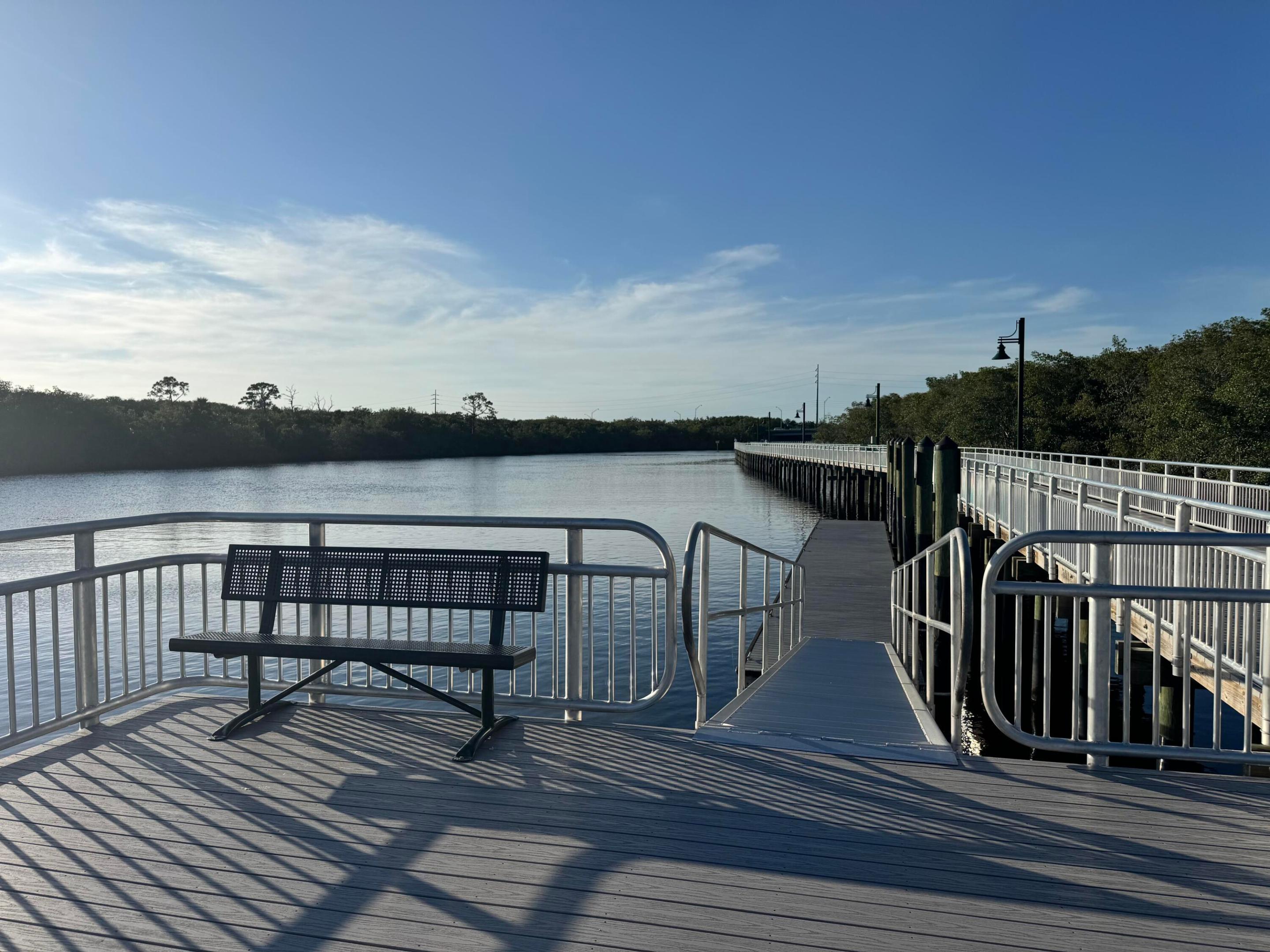 Relax and take in the tranquil water views from this inviting waterfront observation deck, complete with seating. A peaceful spot to enjoy nature near Sandpiper Bay!