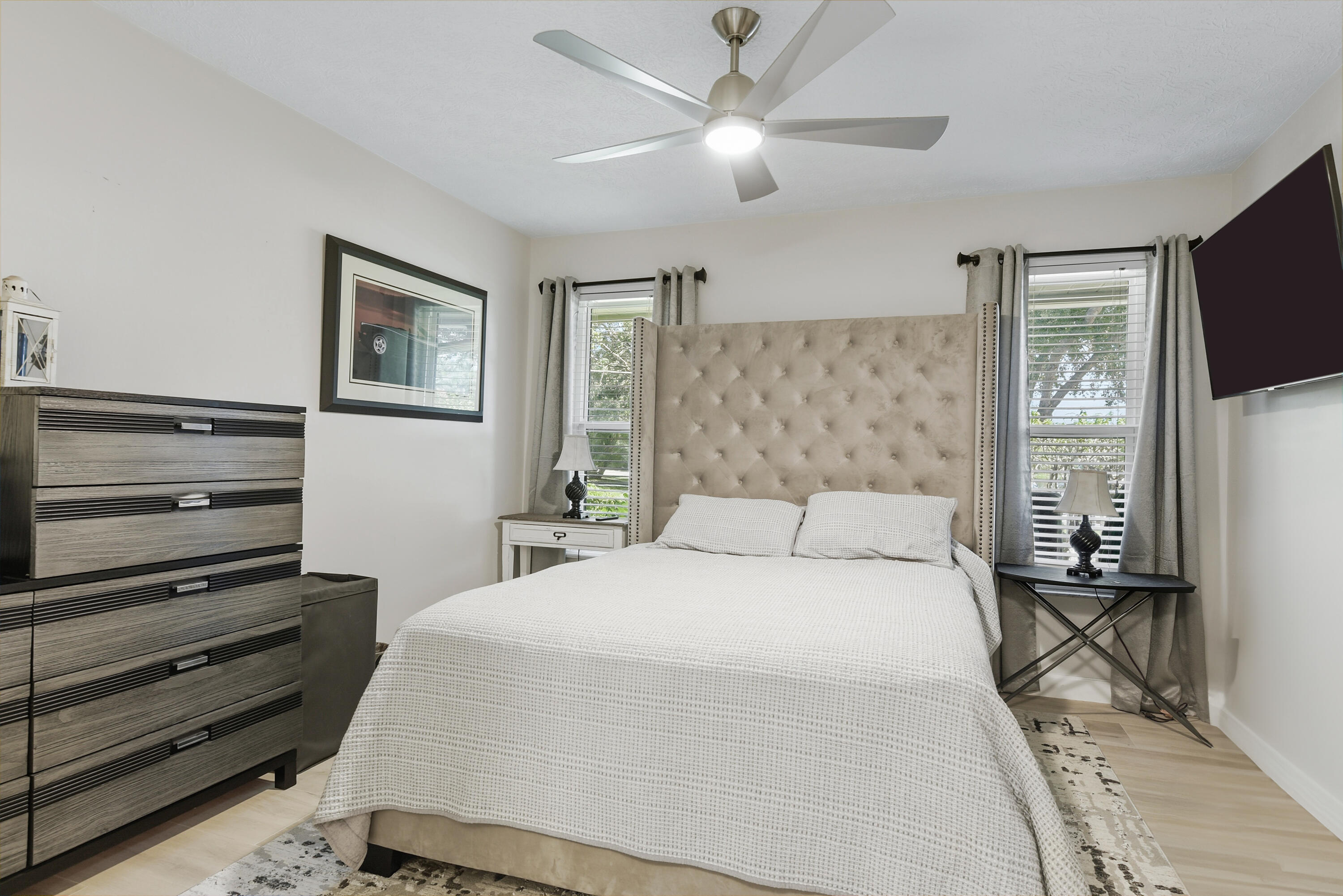 The desirable triple-split floor plan offers exceptional privacy! Bedroom 2 features its own ensuite bath, making it ideal for guests, extended family, or a mother-in-law arrangement. Beautiful flooring and a new ceiling fan complete the space.