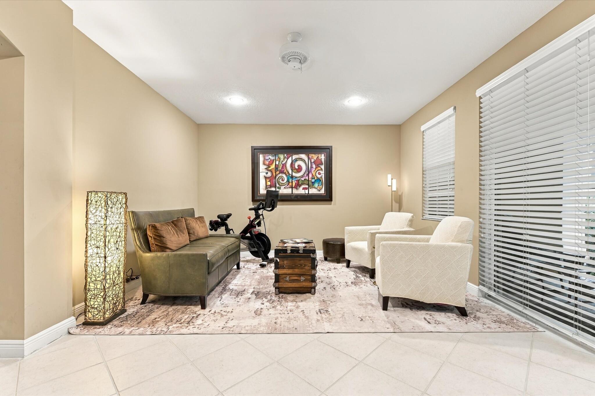 Neutral-toned room featuring diagonal-set tile flooring, recessed lighting, a ceiling-mounted light fixture, and horizontal window blinds