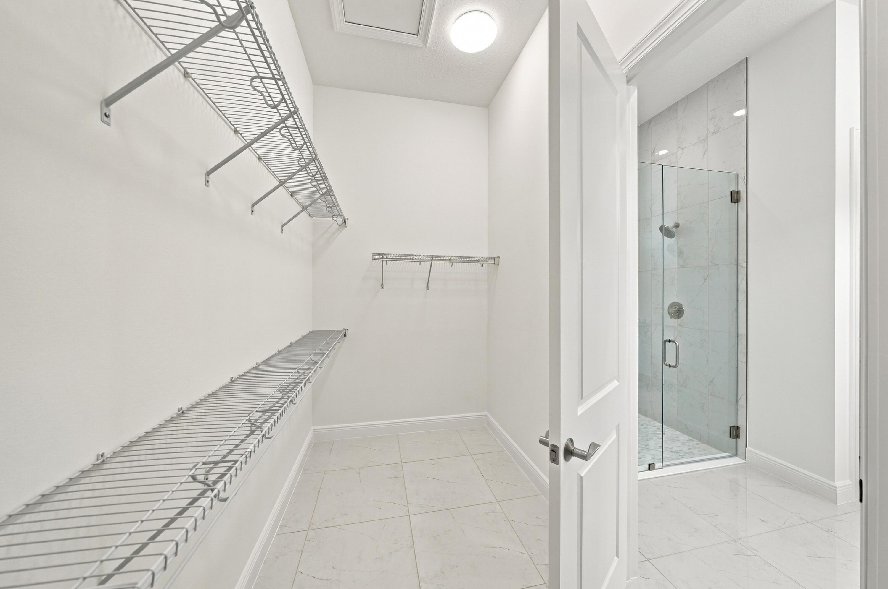 Primary bedroom walk-in closet