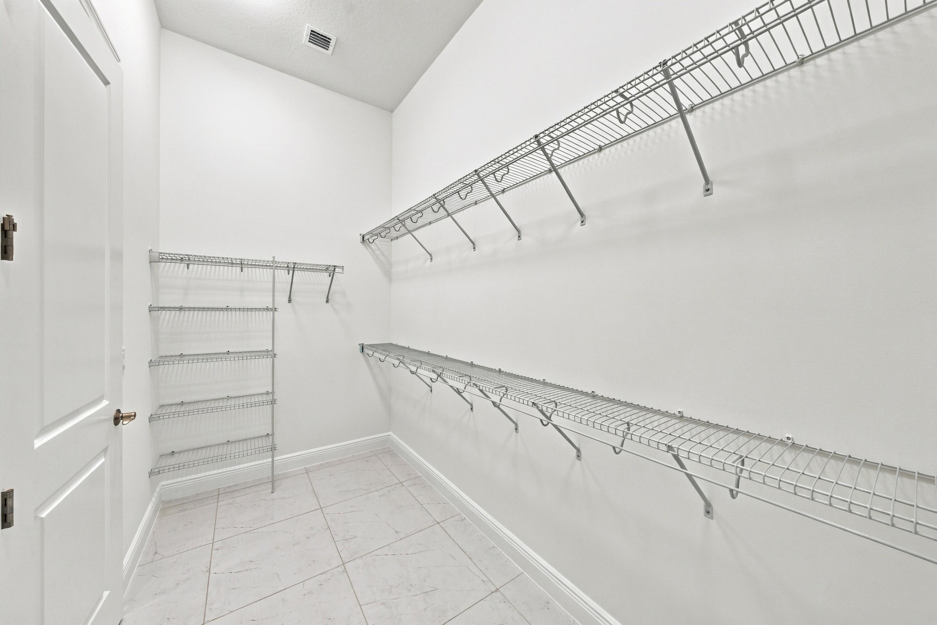 Primary bedroom walk-in closet