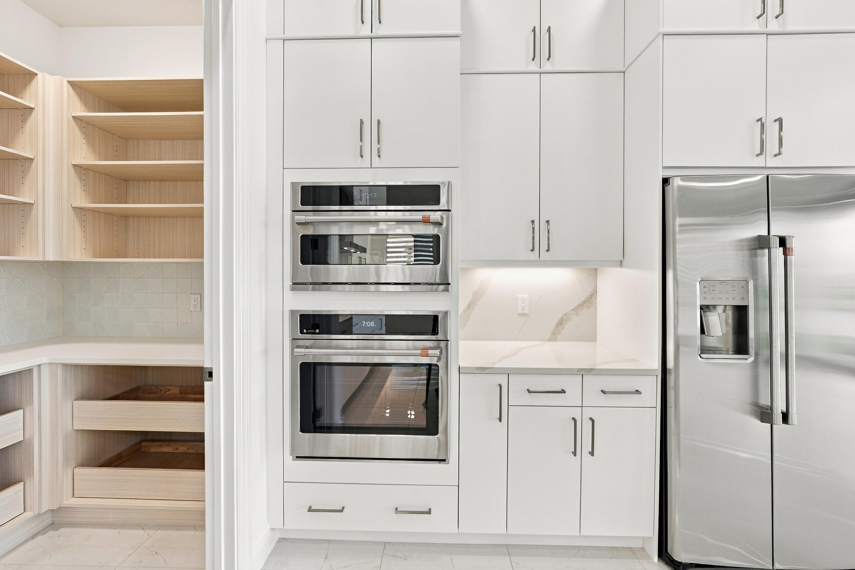GE cafe appliances and walk-in built out pantry with quartz countertop/soft close drawers with plenty of stoarge