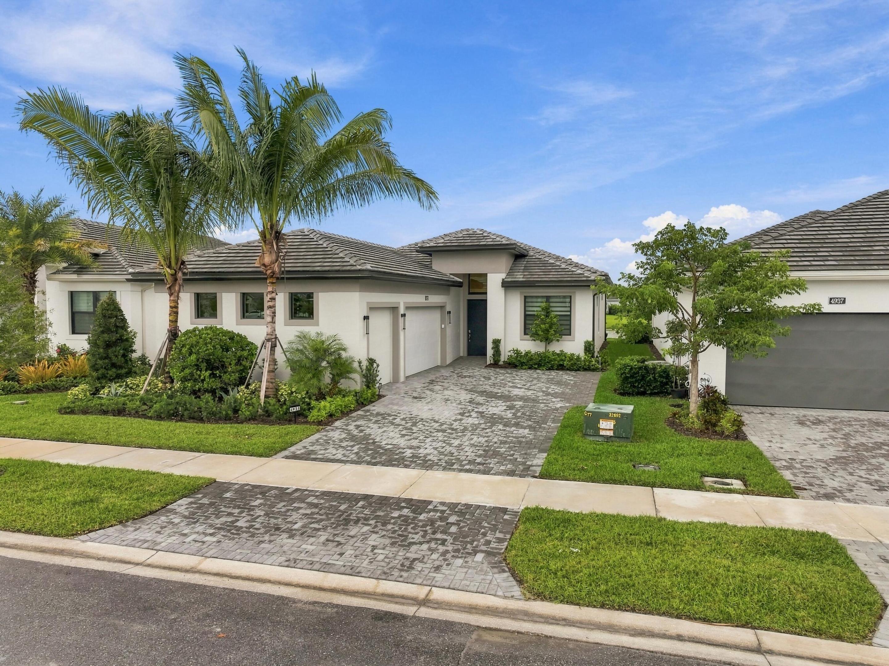 Lila model with lush landscaping and paved driveway Lila model with lush landscaping and paved driveway