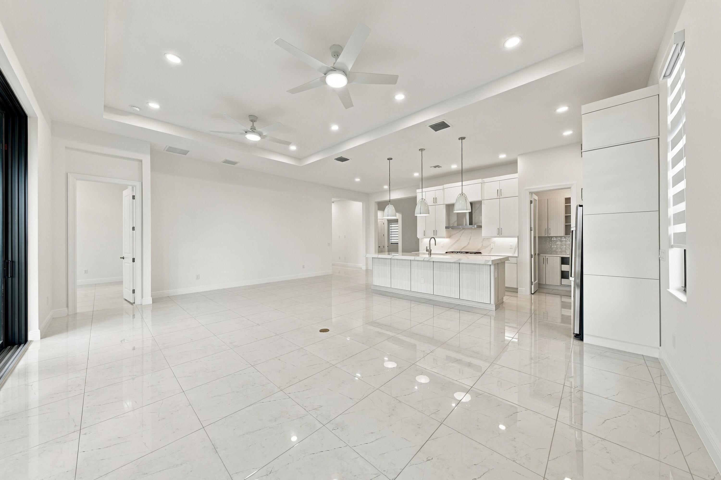 Dining area, great room and kitchen with raised tv outlet and level 5 upgraded tile floors throughout the home