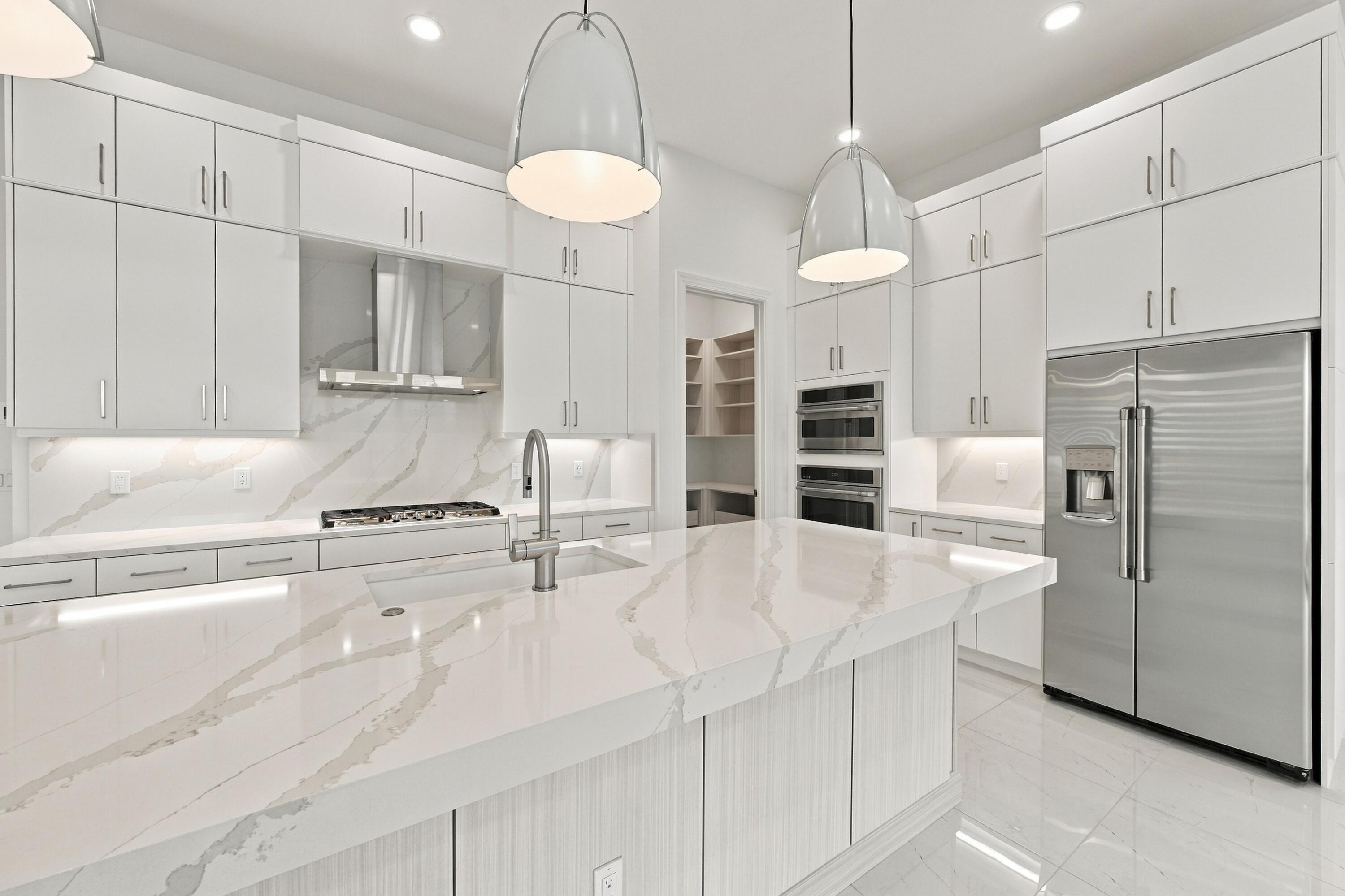 Upgraded soft close doors and cabinets with crown molding, under cabinet lighting and granite sink