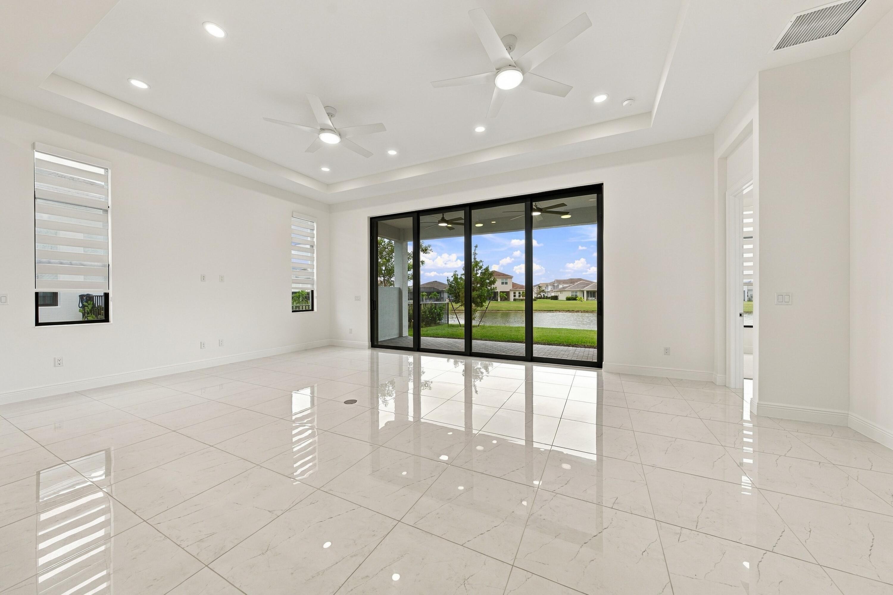 Great room and dining area, tray ceiling, ceiling fans, zebra blinds and 10ft sliders