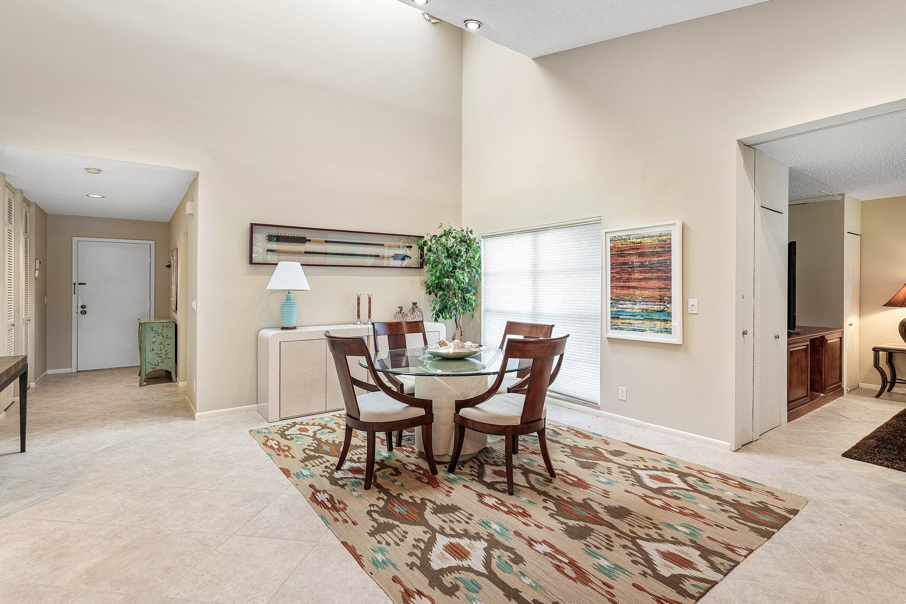 High-ceiling interior space featuring a skylight, neutral-toned tile flooring, and recessed lighting