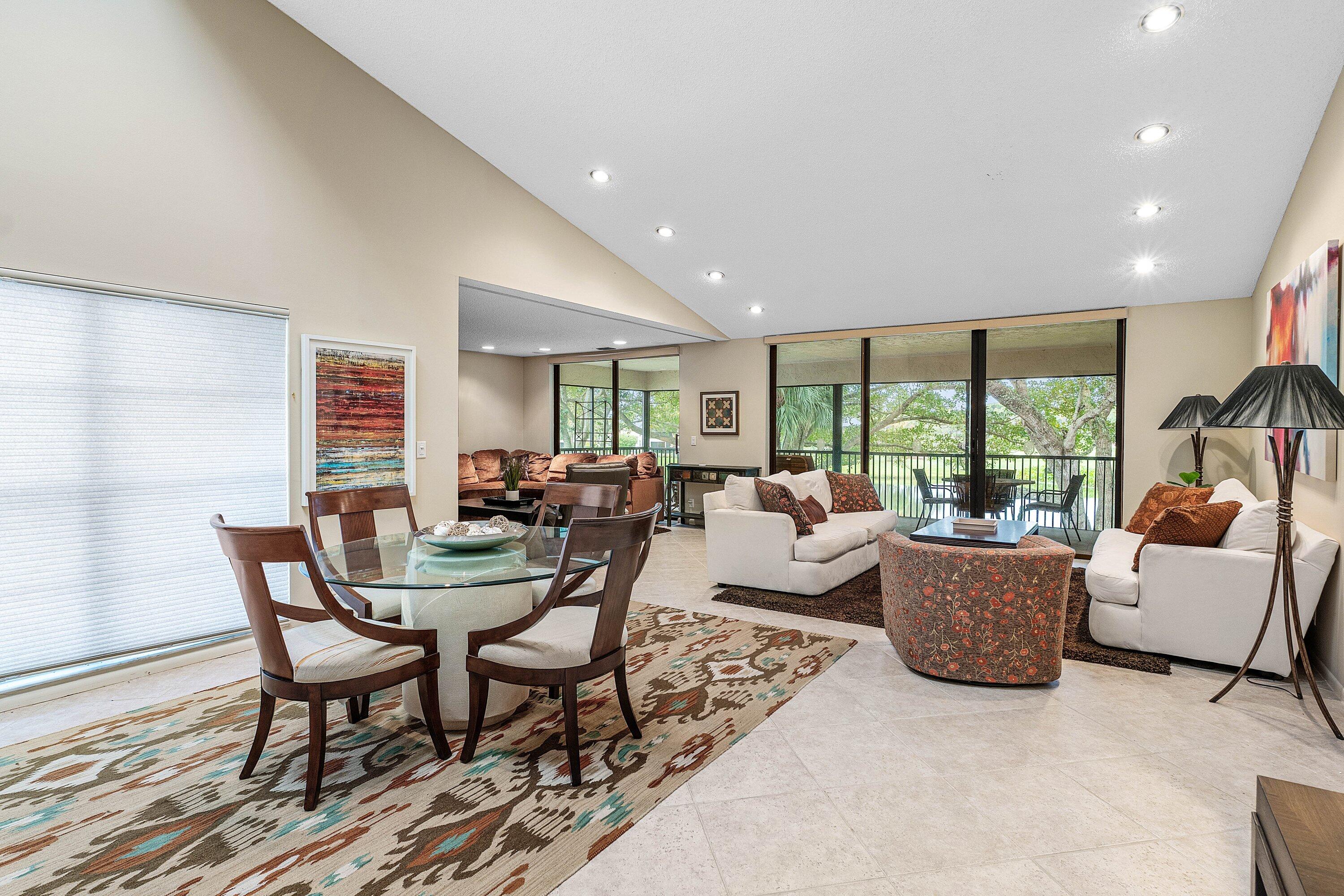 Vaulted ceilings featuring recessed lighting, large-format tile flooring, and floor-to-ceiling sliding glass doors