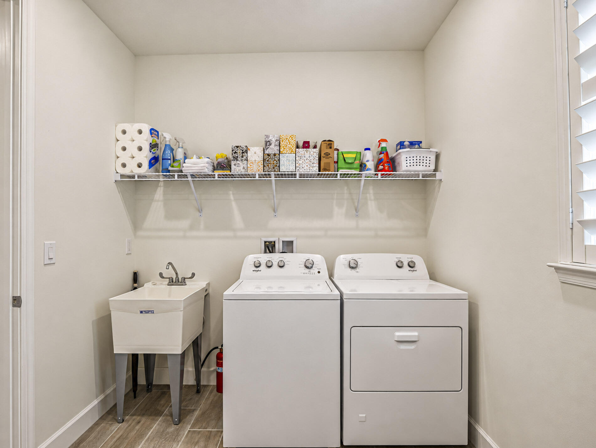 Laundry has extra storage and utility sink