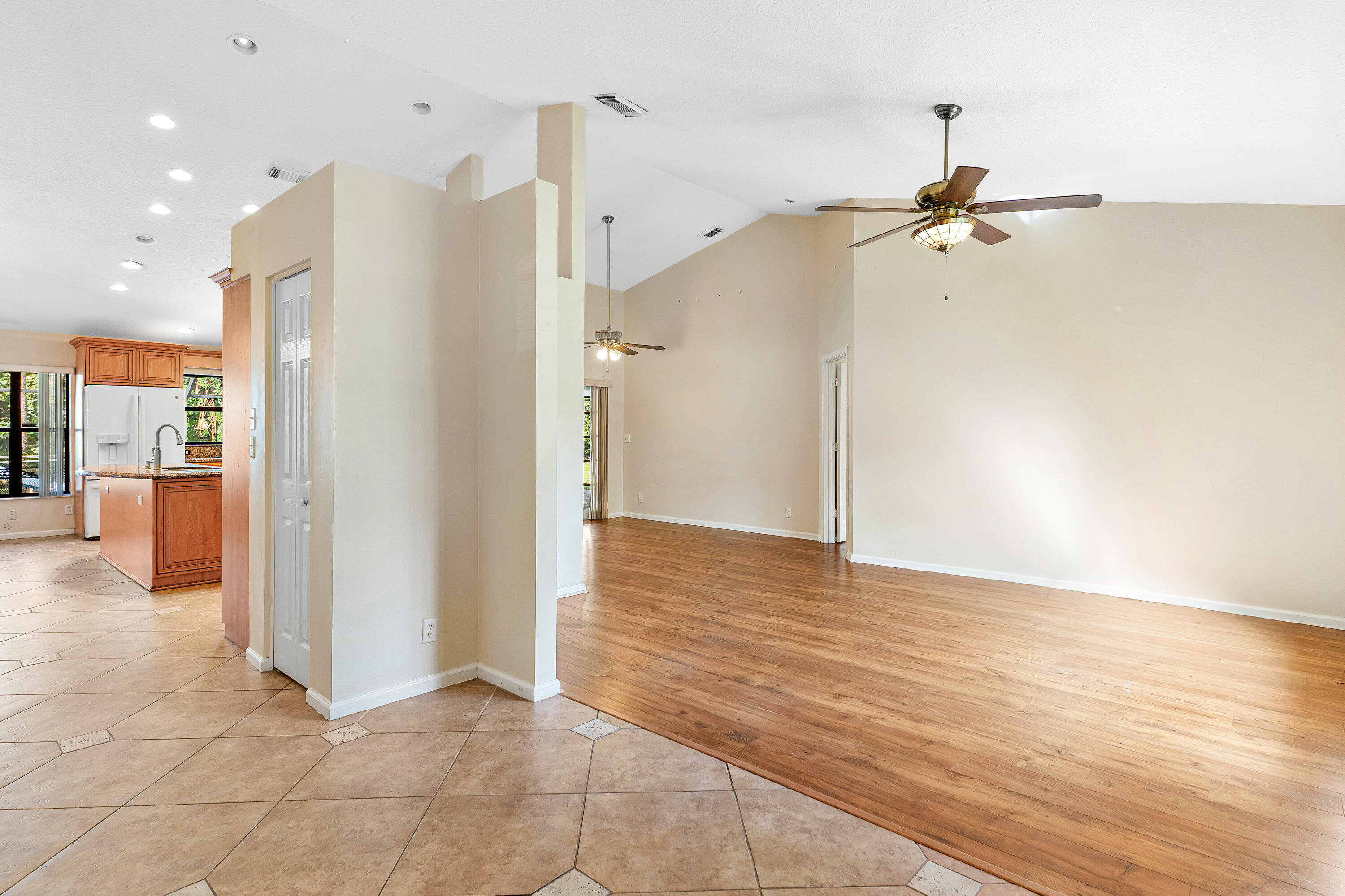 Vaulted ceilings, wood-finish flooring, recessed lighting, ceiling fans, and ceramic tile flooring