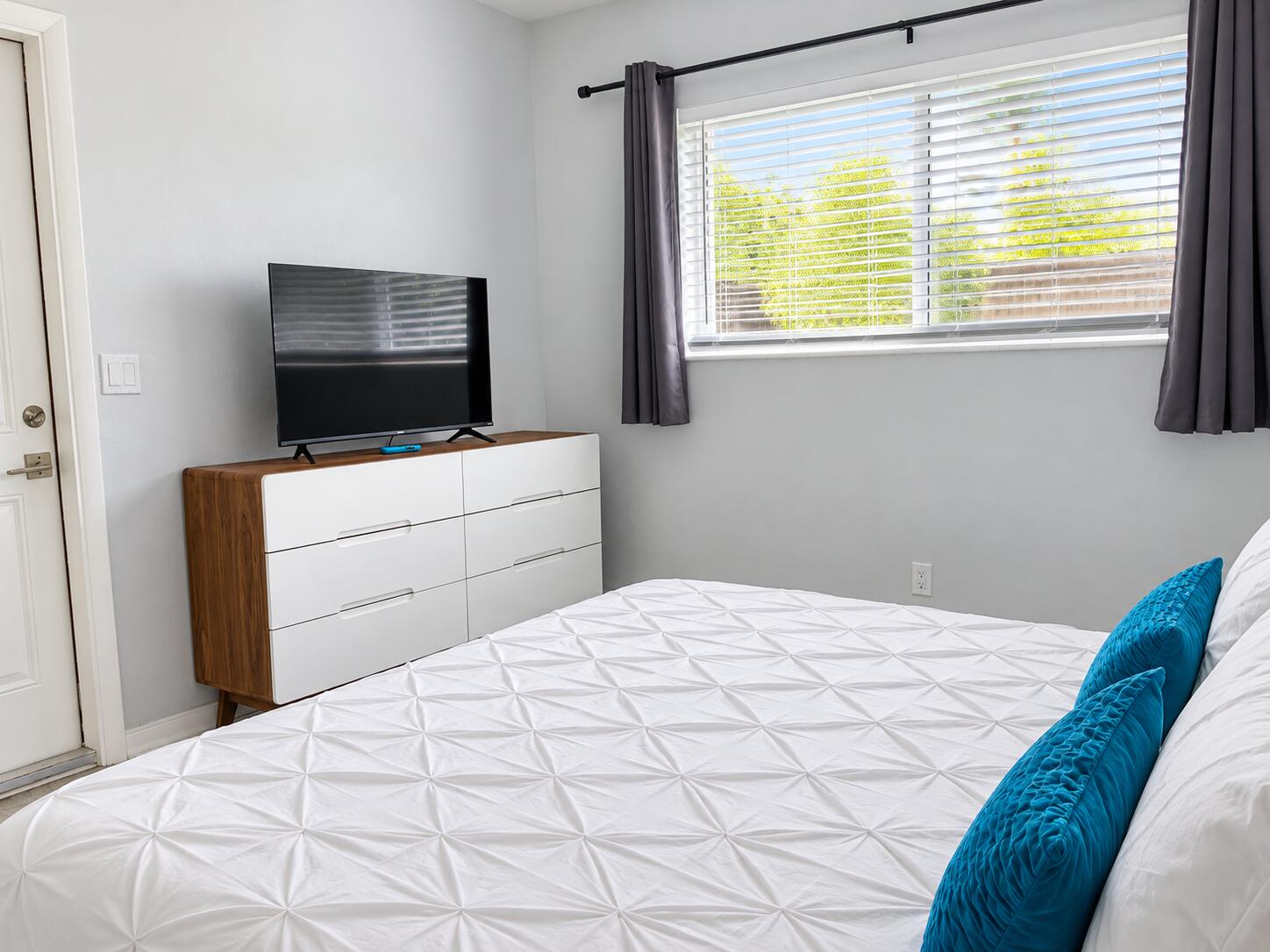 Sunlit Modern Bedroom with Teal Accents