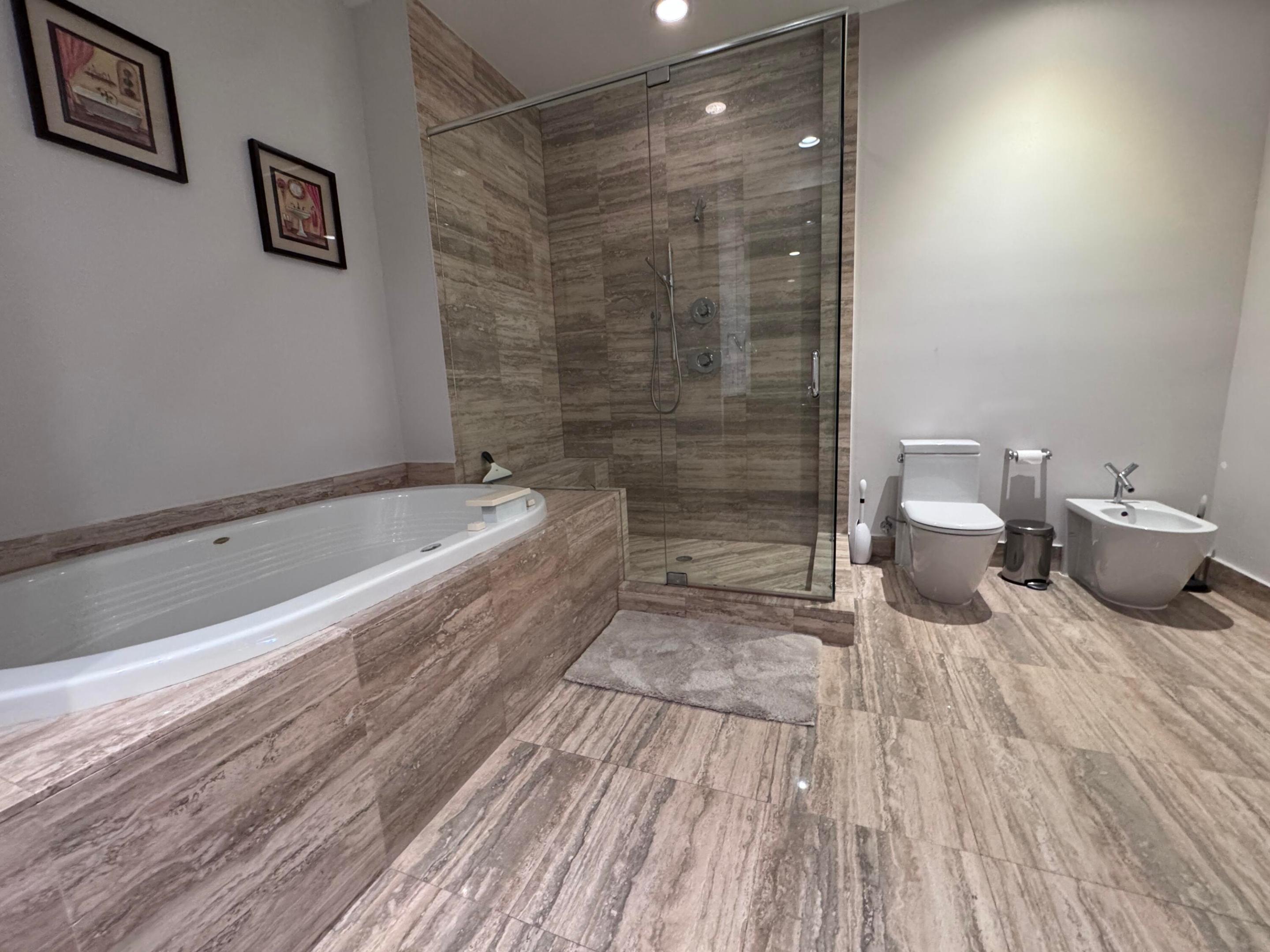 Sunk in spa with separate shower.