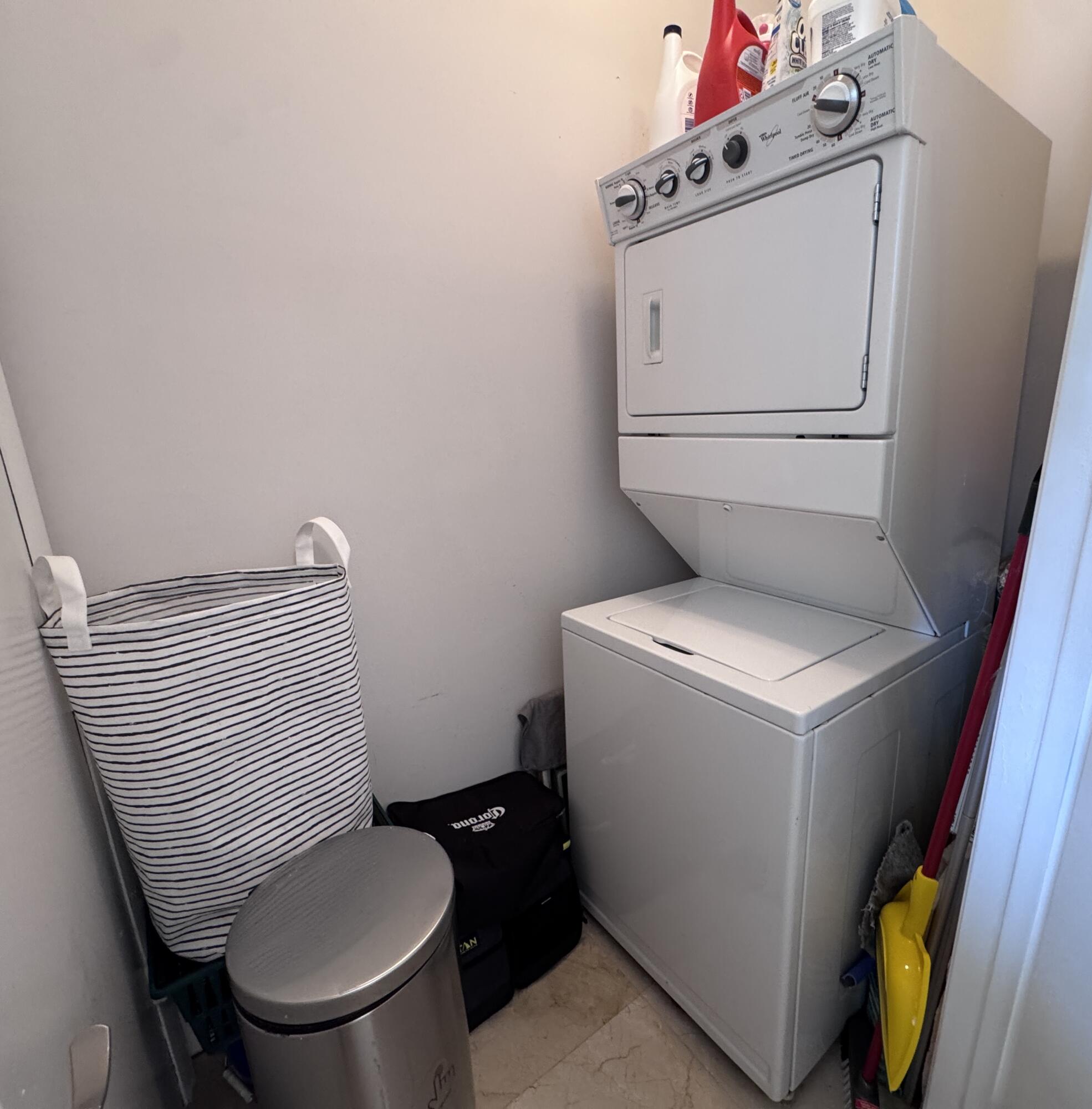 Full size washer / dryer in separate closet in kitchen.