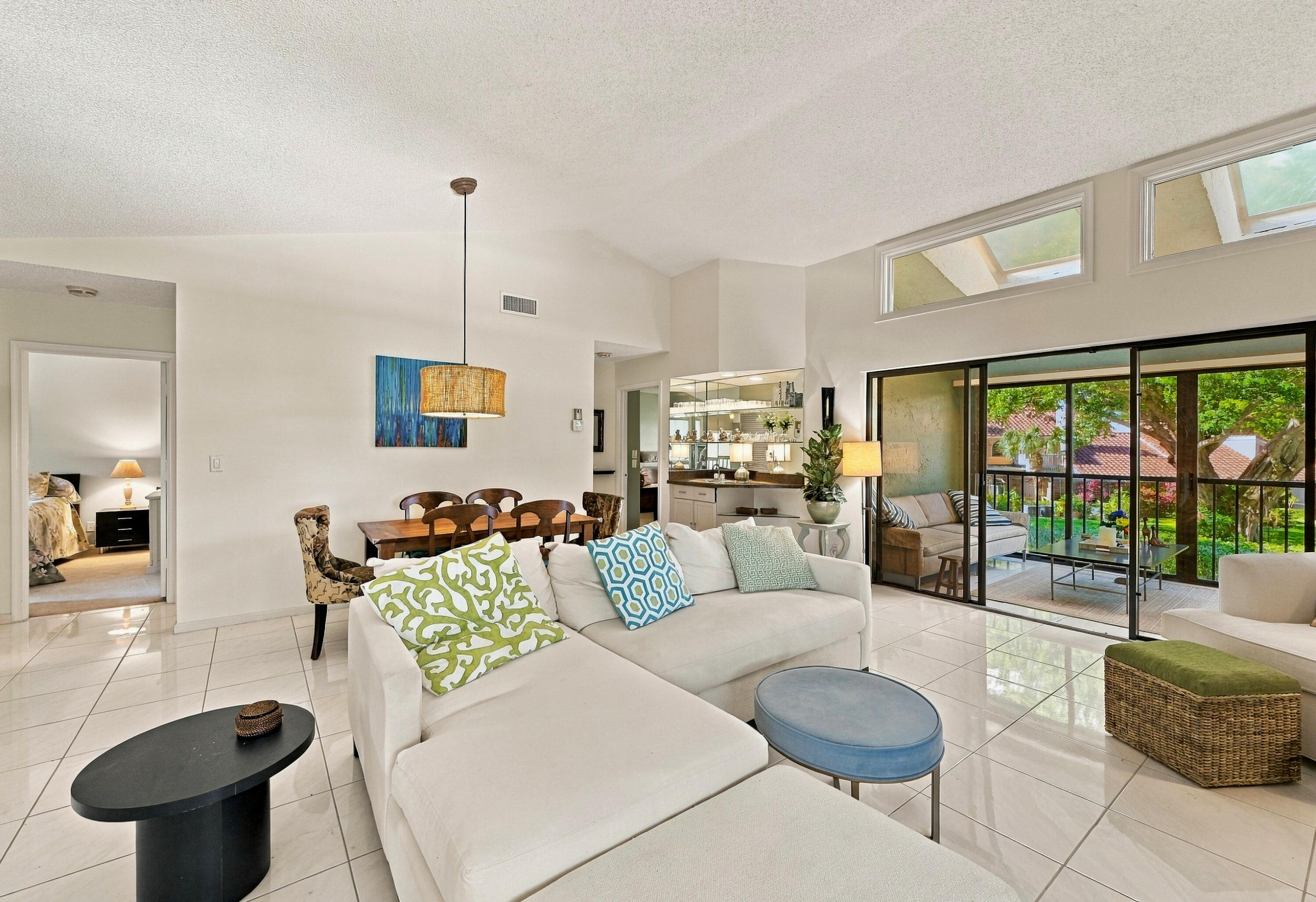 Your living room/dining room has high ceilings and a pretty, green view