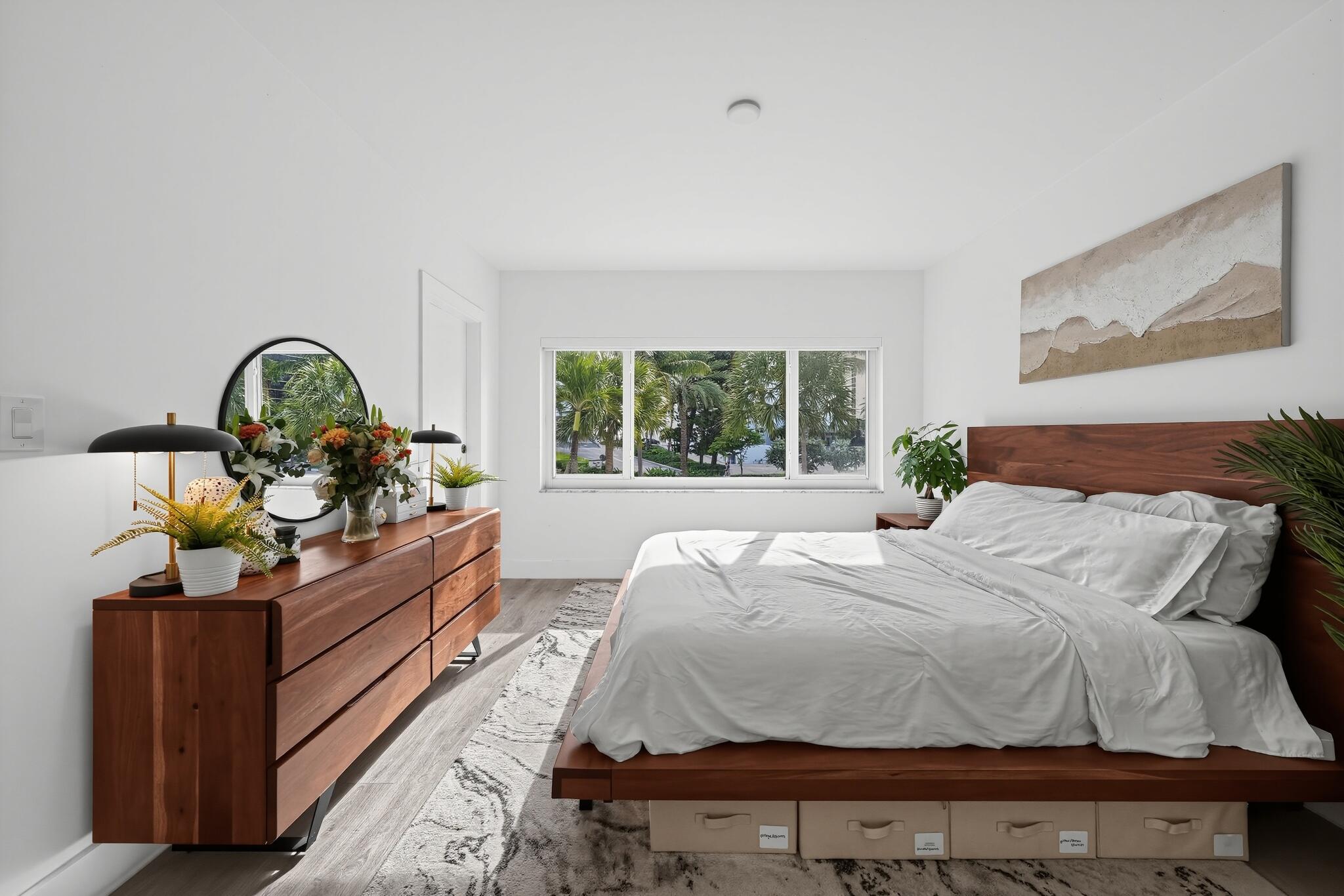 Large bedroom also has door that opens onto balcony.