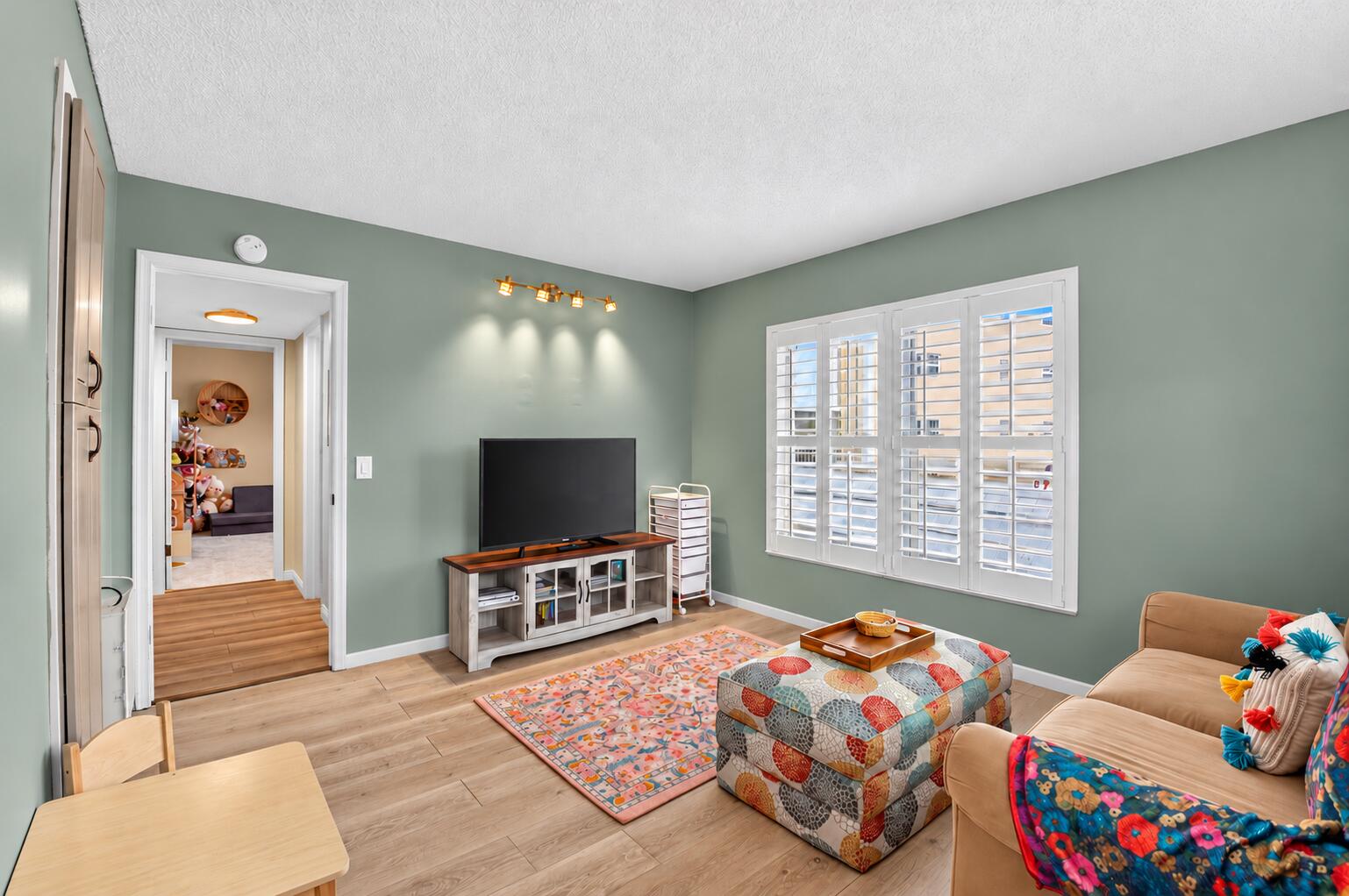 Green room with low white baseboards