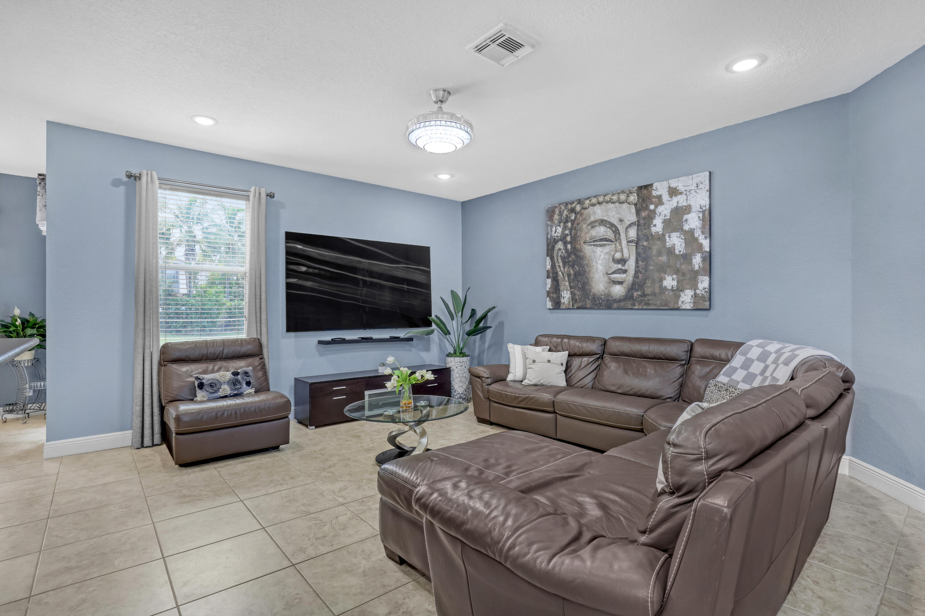 Living space featuring neutral ceramic tile flooring, recessed lighting, a decorative ceiling fan Living space featuring neutral ceramic tile flooring, recessed lighting, a decorative ceiling fan