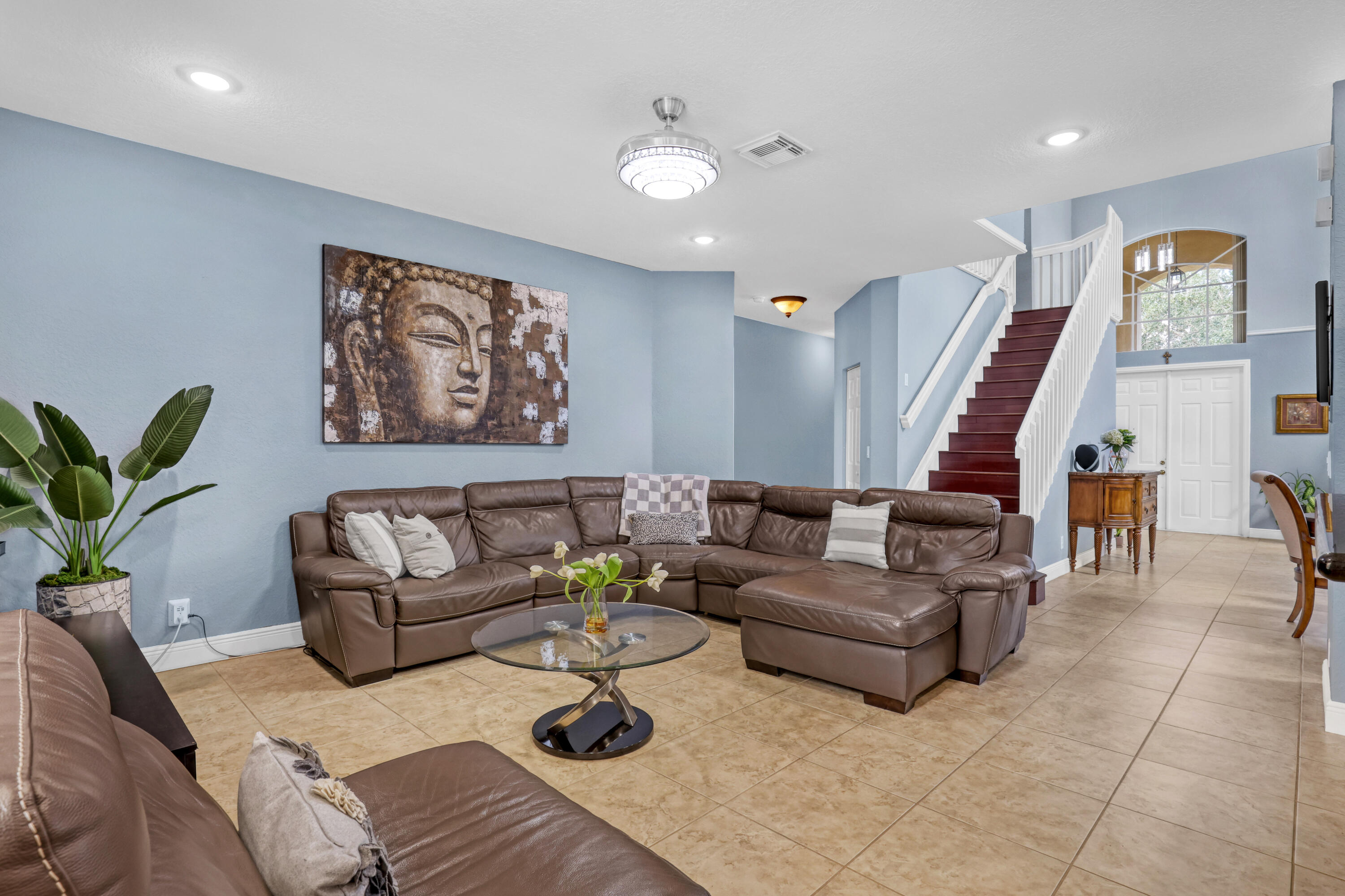 Open-concept interior featuring large-format tile flooring, recessed lighting, a modern ceiling fan Open-concept interior featuring large-format tile flooring, recessed lighting, a modern ceiling fan