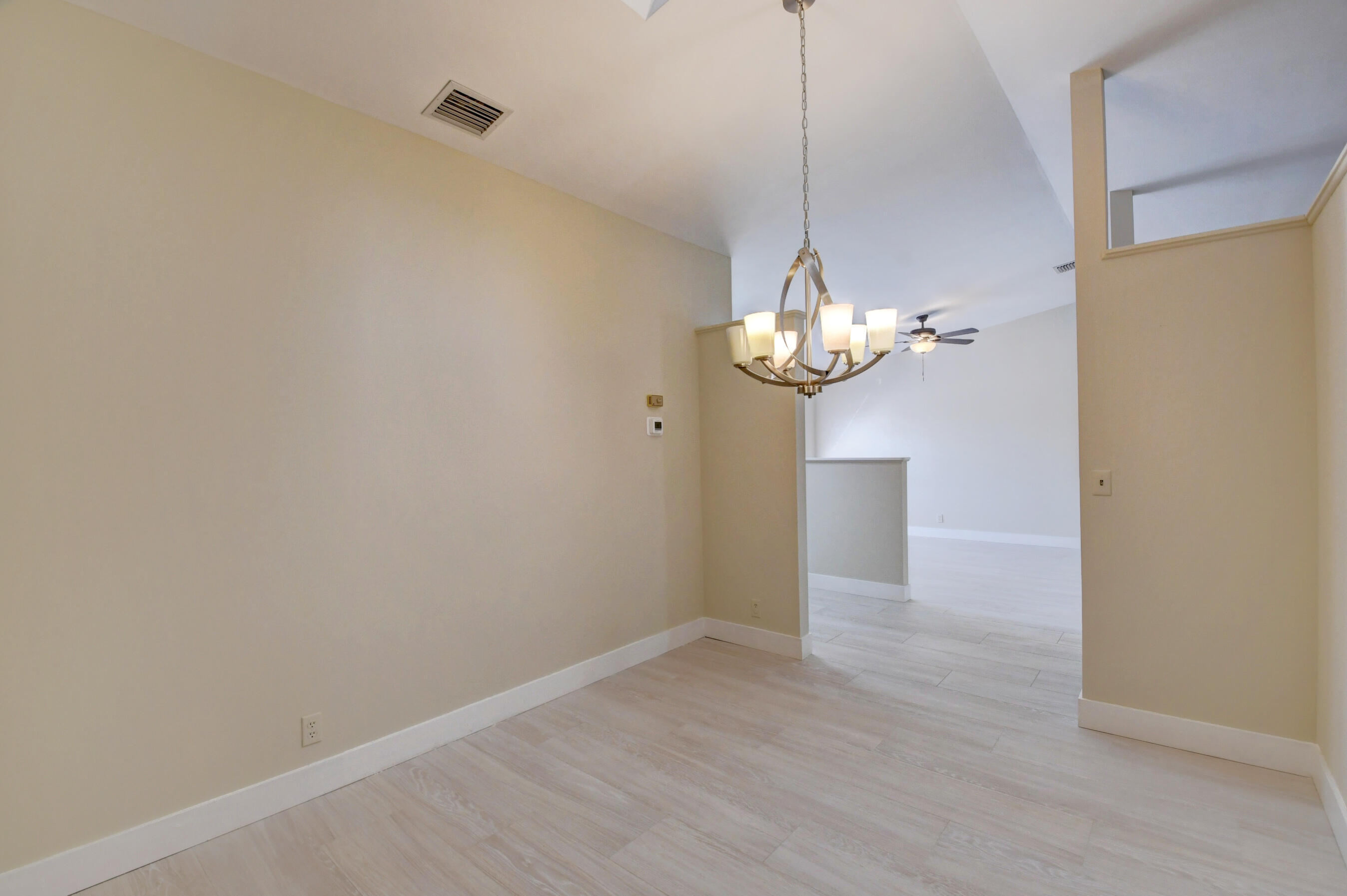 Elegant Dining Area with Chandelier & Vaulted Ceiling Elegant Dining Area with Chandelier & Vaulted Ceiling