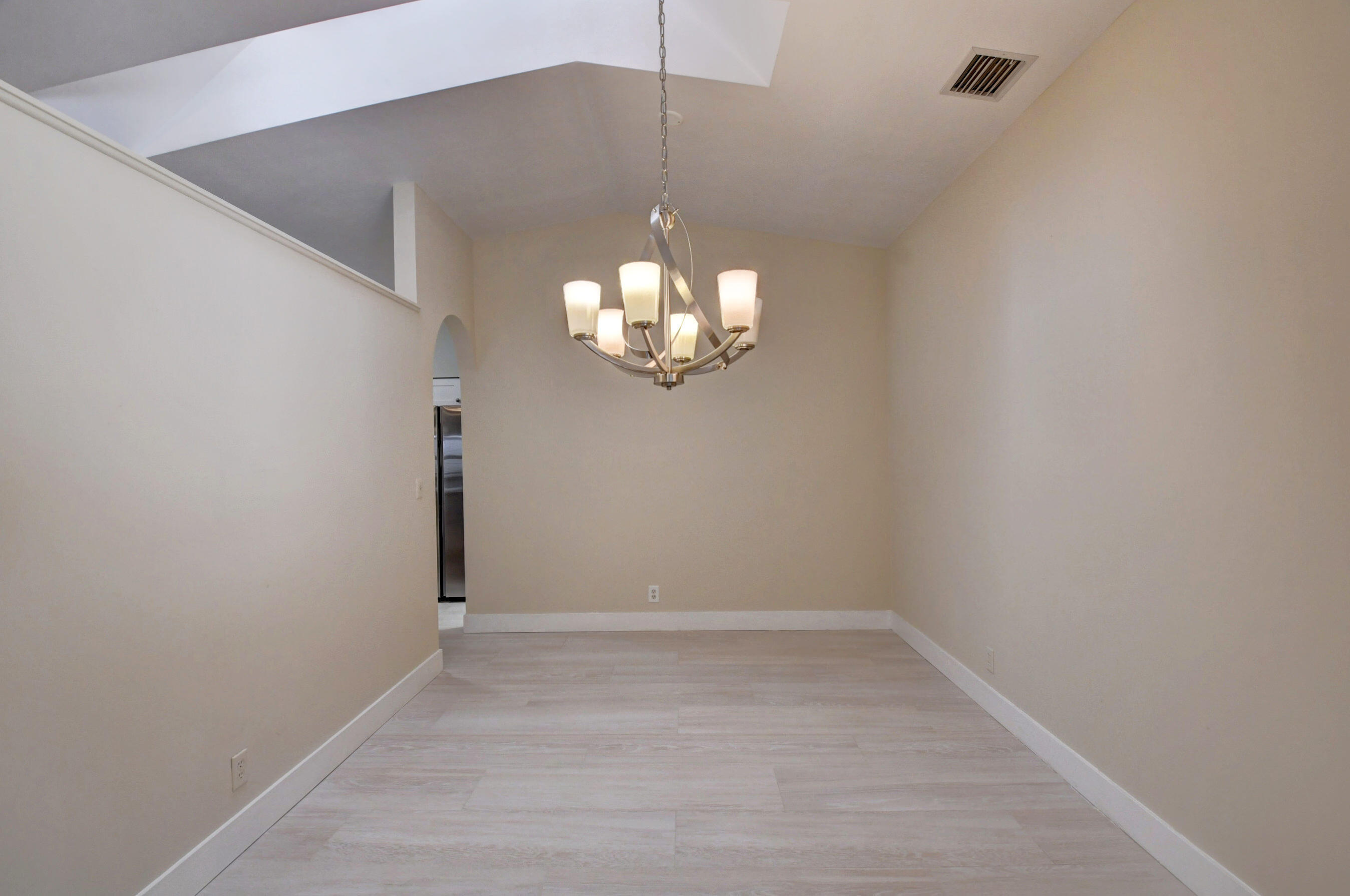 Elegant Dining Area with Chandelier & Vaulted Ceiling Elegant Dining Area with Chandelier & Vaulted Ceiling