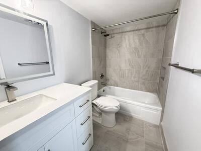 Full bath with tub/shower, updated fixtures and new tile.