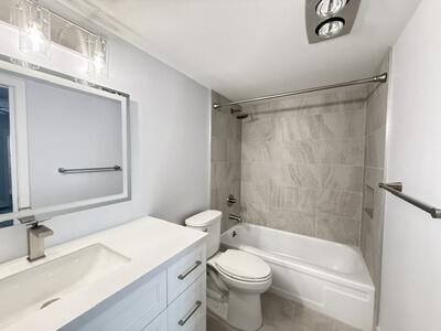 Full bath with tub/shower, updated fixtures and new tile.