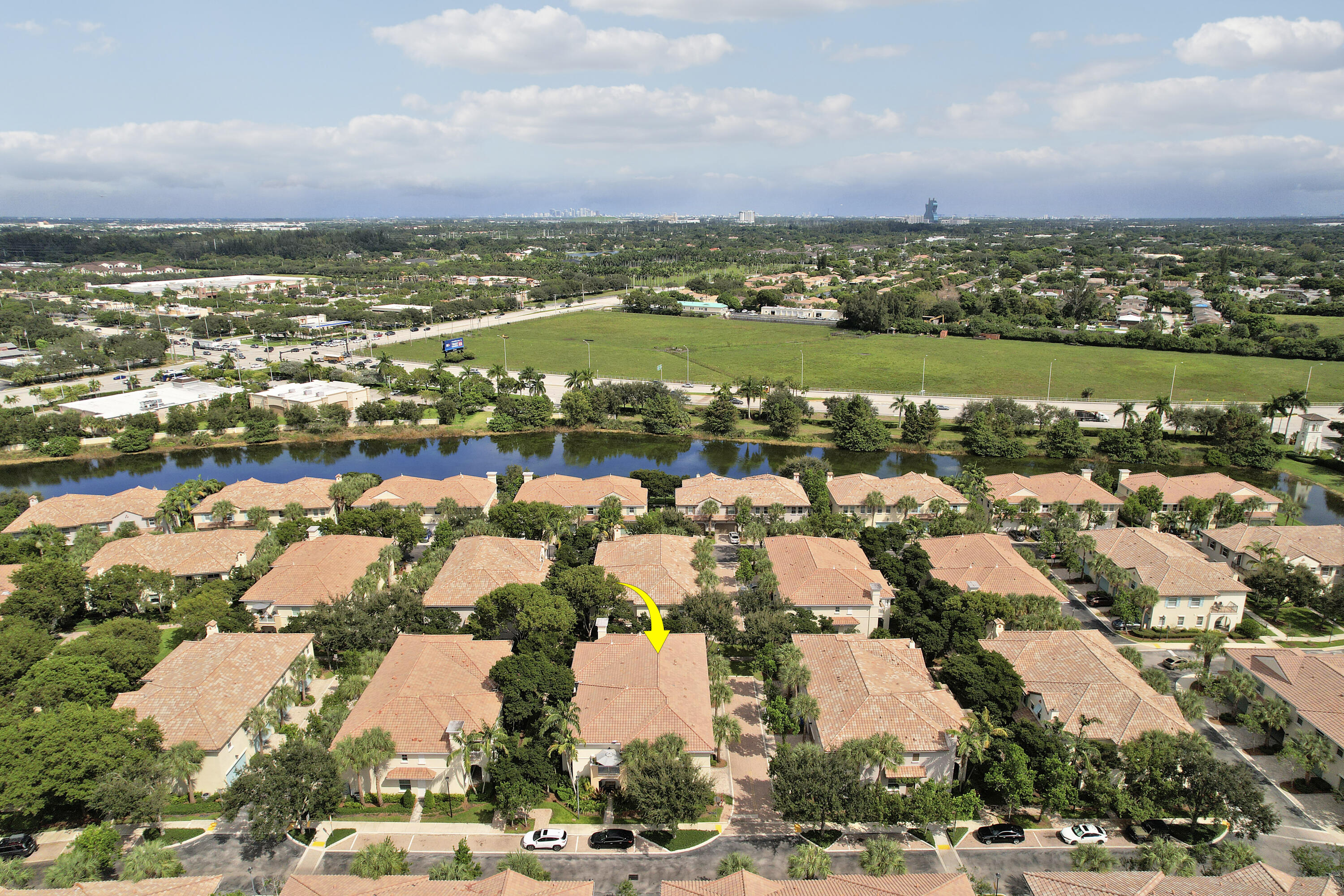 Aerial perspective of property featuring tile roofing and established landscaping within a suburban community