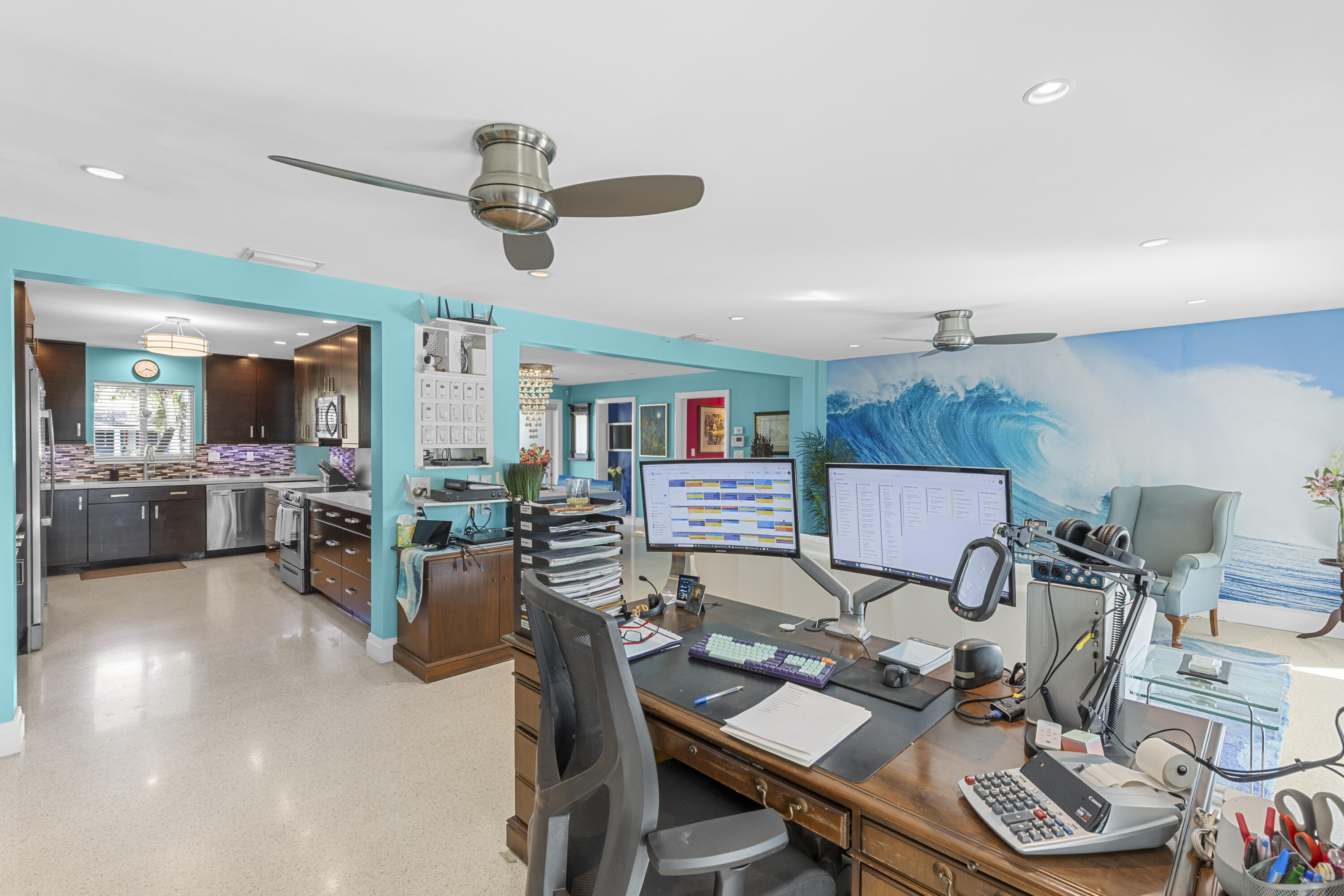 Open-concept interior featuring polished concrete flooring, recessed lighting, and dual ceiling fans