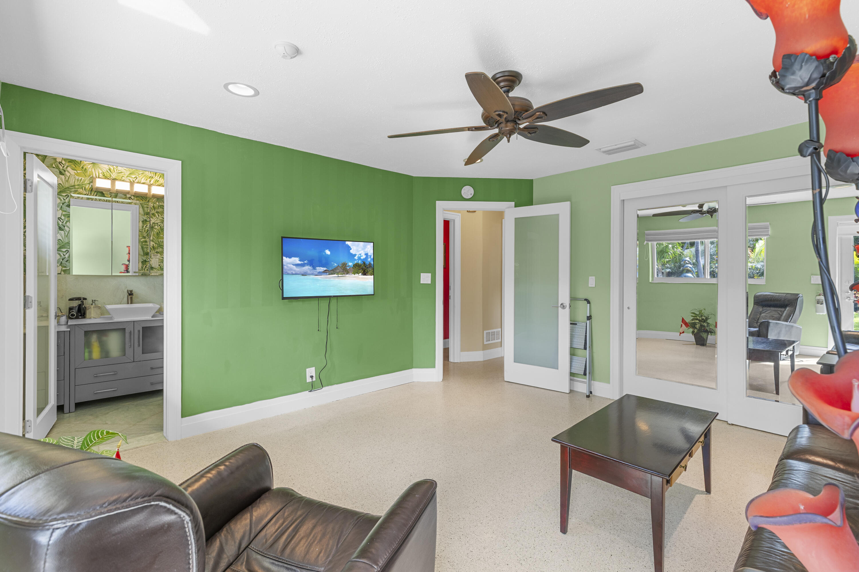 Interior room featuring recessed lighting, a ceiling fan, light-colored flooring, and interior doors with frosted glass inserts