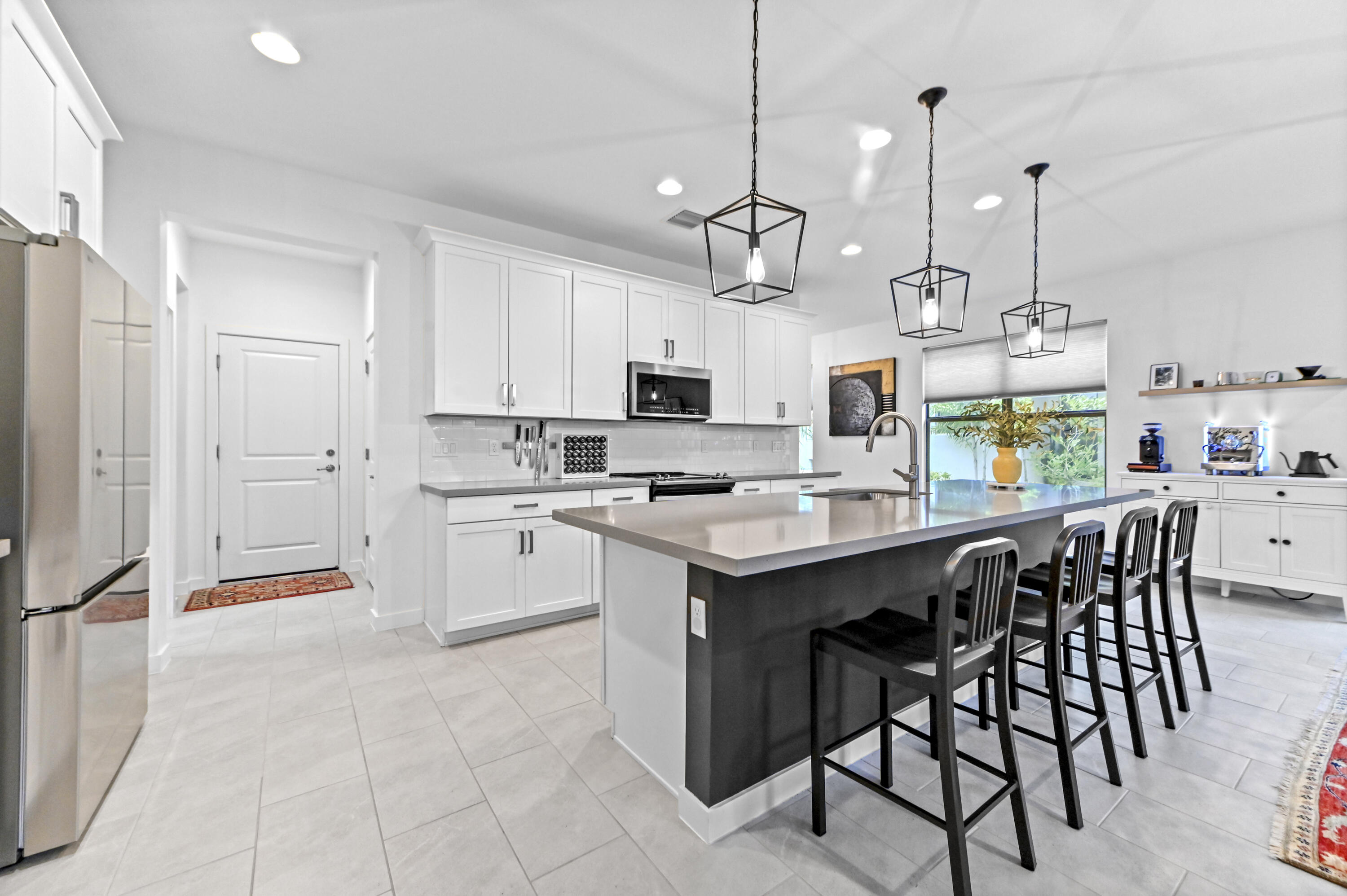 Spacious snack counter with designer lighting and adjacent large pantry