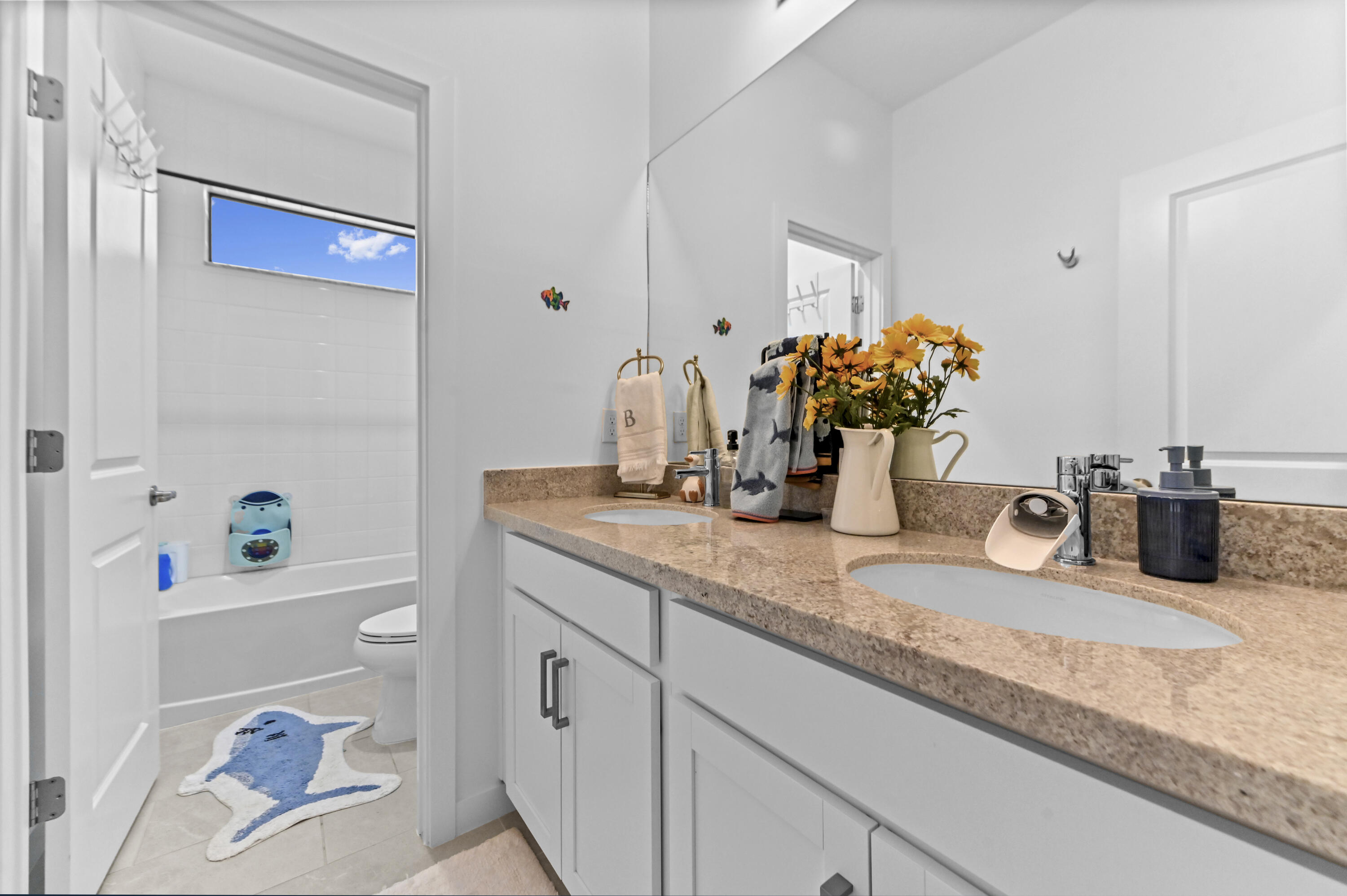 Upstairs Bathroom has double sink vanity with Granite Counter and separate privacy bath tub/shower commode area