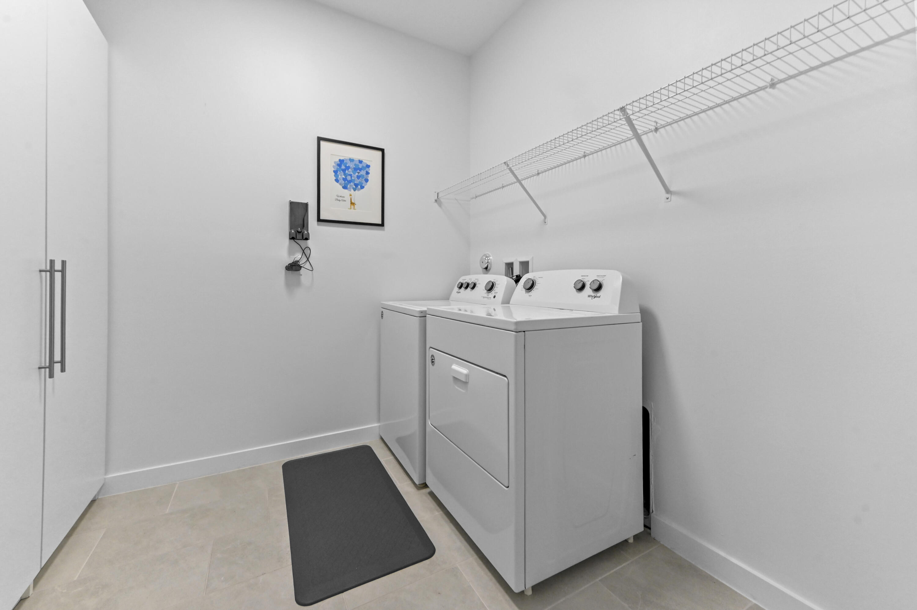 Laundry Room on second floor with full size washer/dryer and storage closet